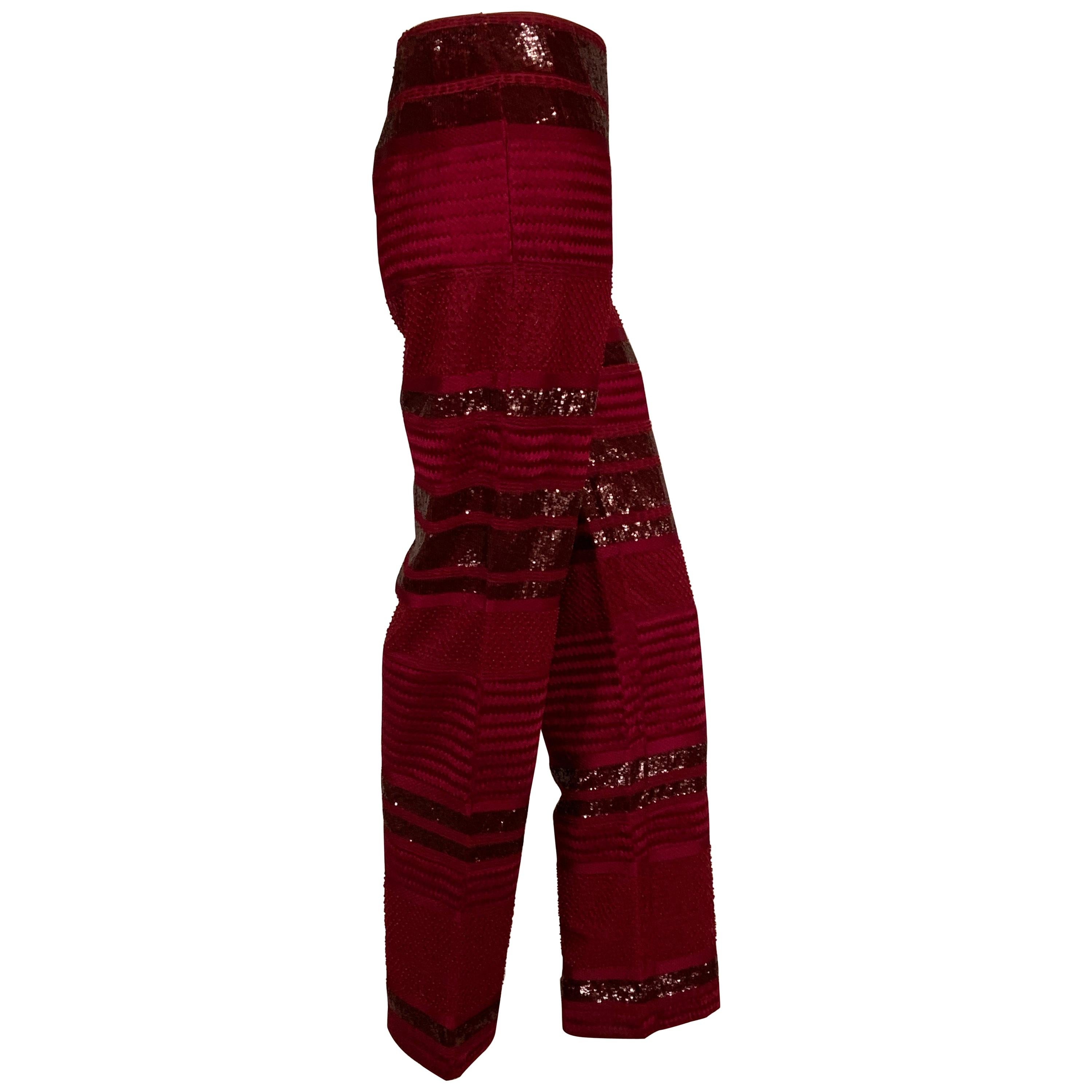 These pants From Chado, Ralph Rucci are all about the fabric, the cut and design of the pants is spare and elegant. No waistband, no pockets, and an invisible left side zipper allows the fabric to be the star. Wine red silk is beaded with wide bands