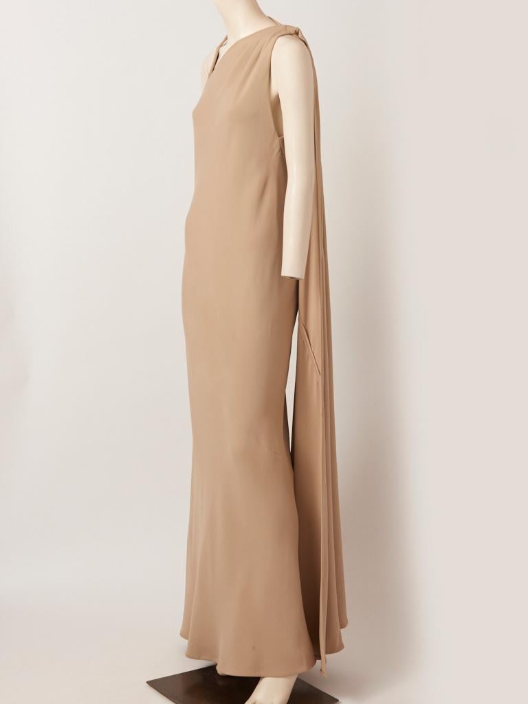 Chado Ralph Rucci, Couture, beige, silk crepe, bias cut gown having a bias cut back panel that drapes from the shoulder to the floor on one side and a neckline that has gentle pleating at one shoulder and a geometric triangle shape at the opposite