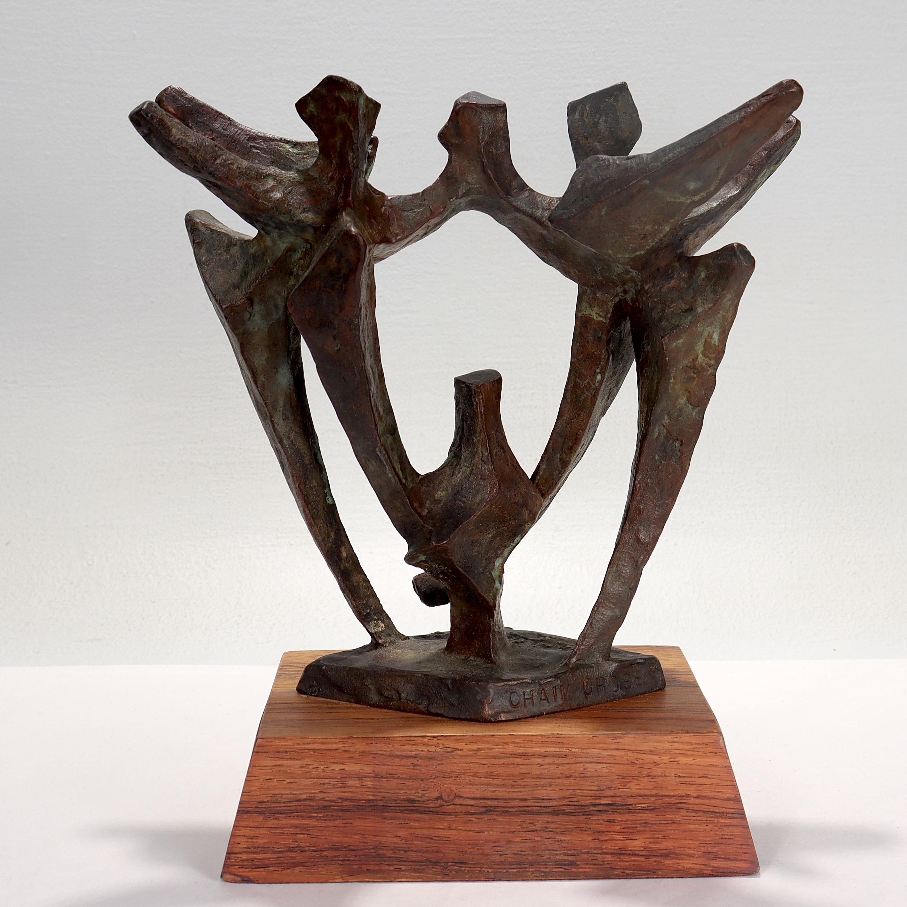 Une belle sculpture abstraite en bronze de style moderne du milieu du siècle.

Par Chaim Gross.

Représentation de danseurs aux bras levés.

Monté sur un socle en bois trapézoïdal.

Signé 