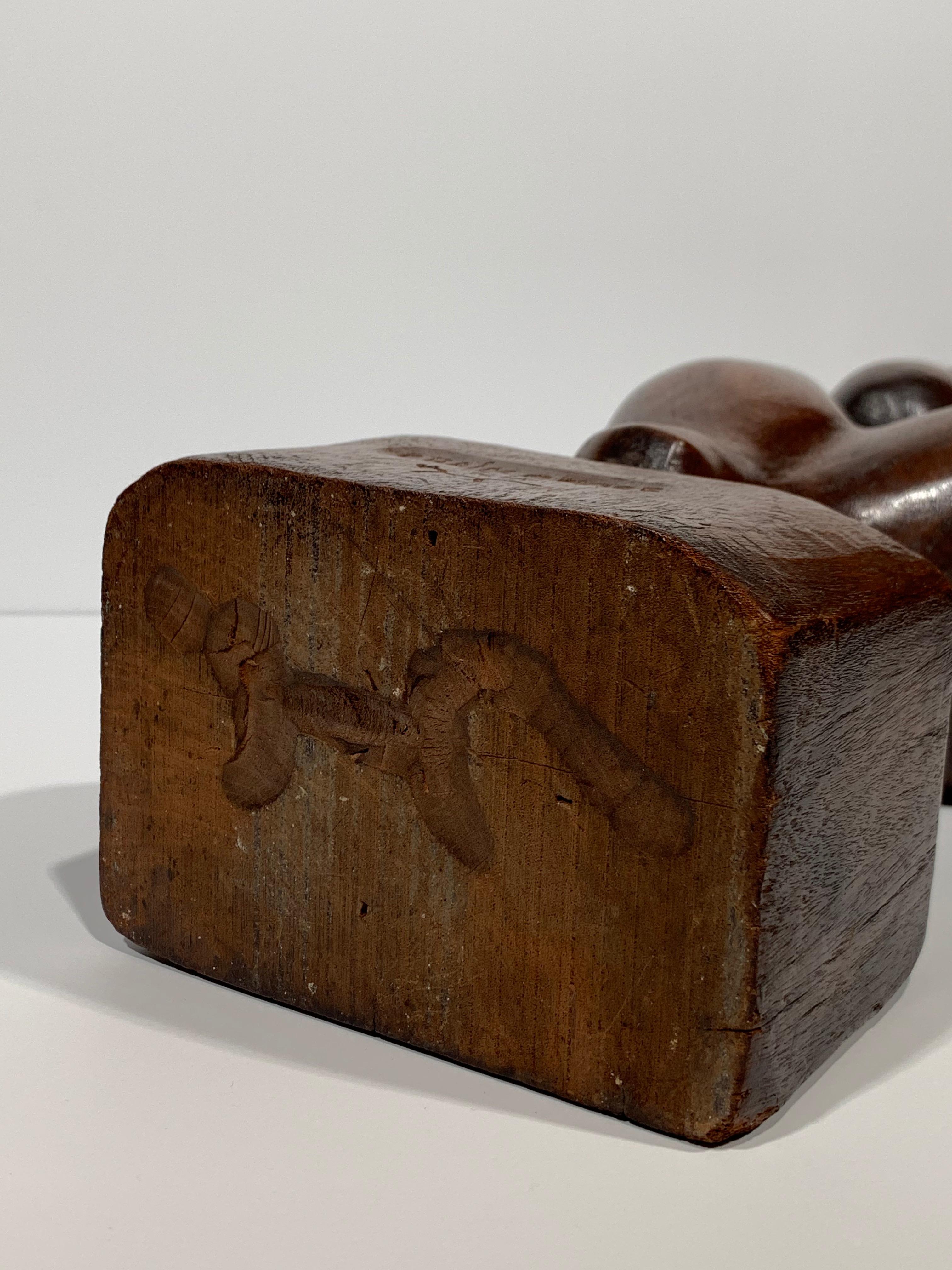 Beautiful sculpture by American artist, Chaim Gross (1904-1991). Woman Brushing Hair, c.1930. Carved mahogany, figure measures 22 inches h; 5.75 inches w; 4 inches d. Signed at base. Excellent condition with one naturally occurring split on the