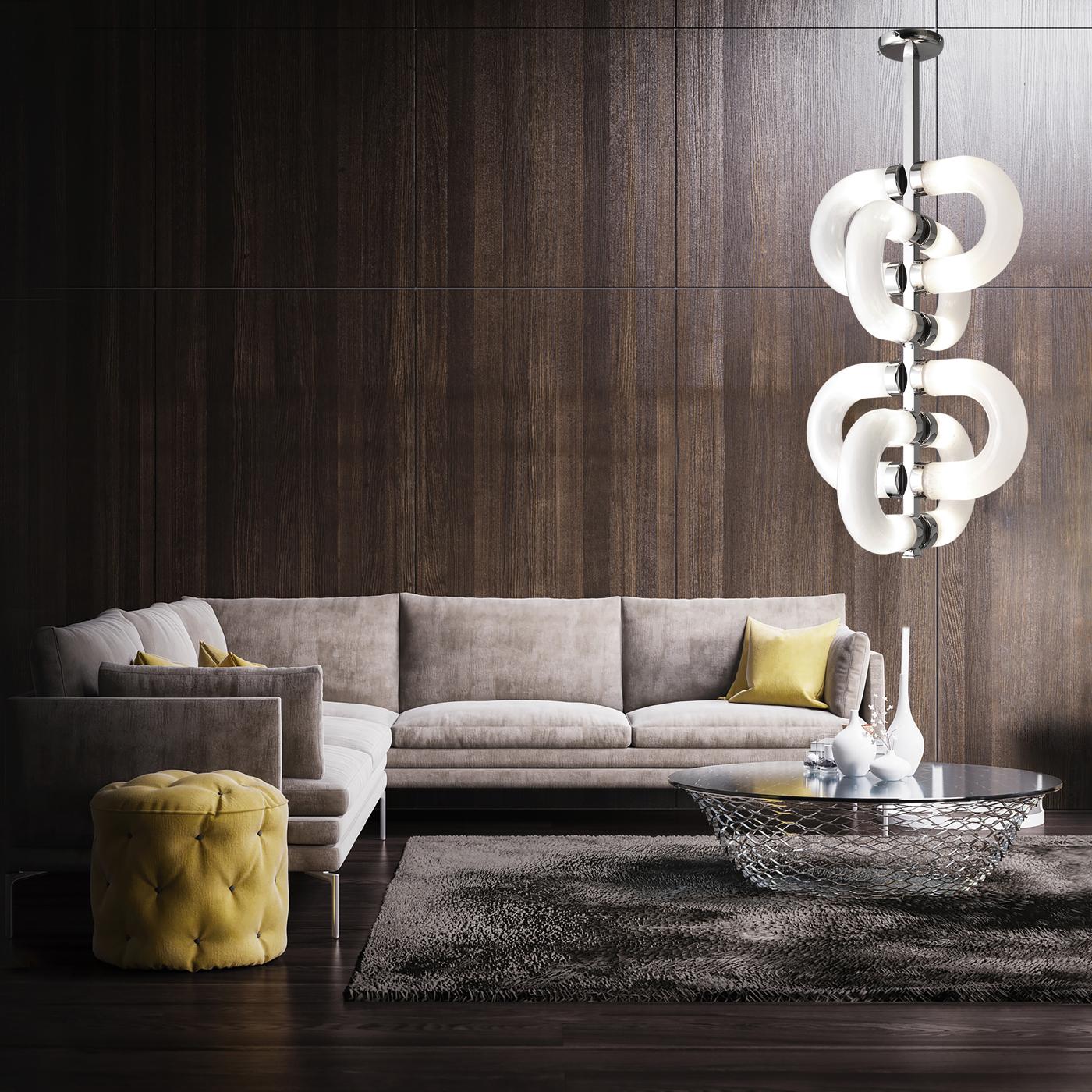 The enthralling design of this sophisticated chandelier is achieved through the interlocking silhouette of cylindrical glass links, whose halves are connected to the chrome-finished, central metal frame of the chandelier. Each of these sections