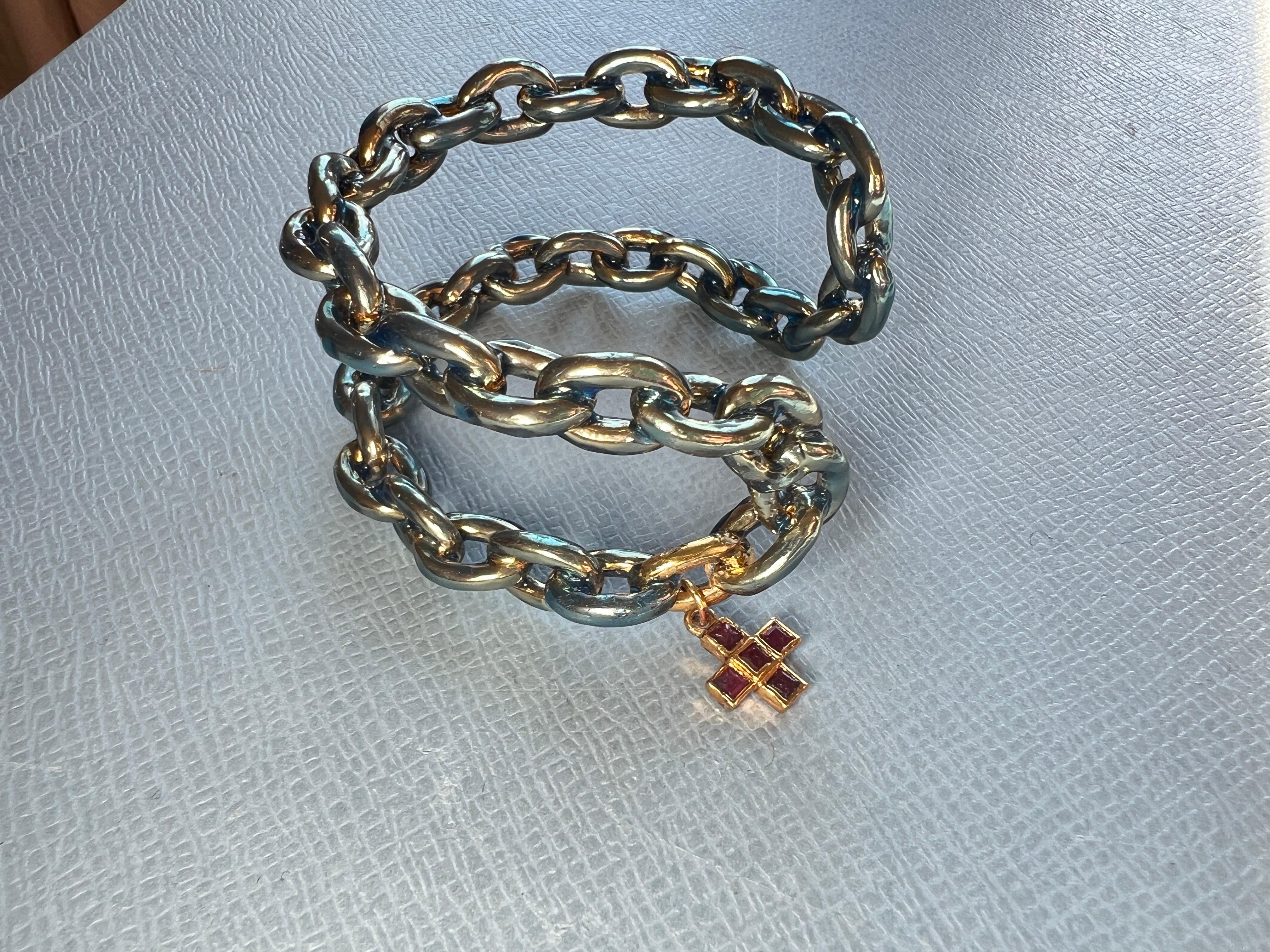 Chain Cuff Bangle Bracelet – Light Blue Enamel and Ruby Cross

Material: Gold Plated Brass
Handpainted Enamel: Light Blue
Cross: 5 Square Rubies
Designer: J Dauphin

This cuff bangle features a Greek cross, one of the oldest universal symbols, found