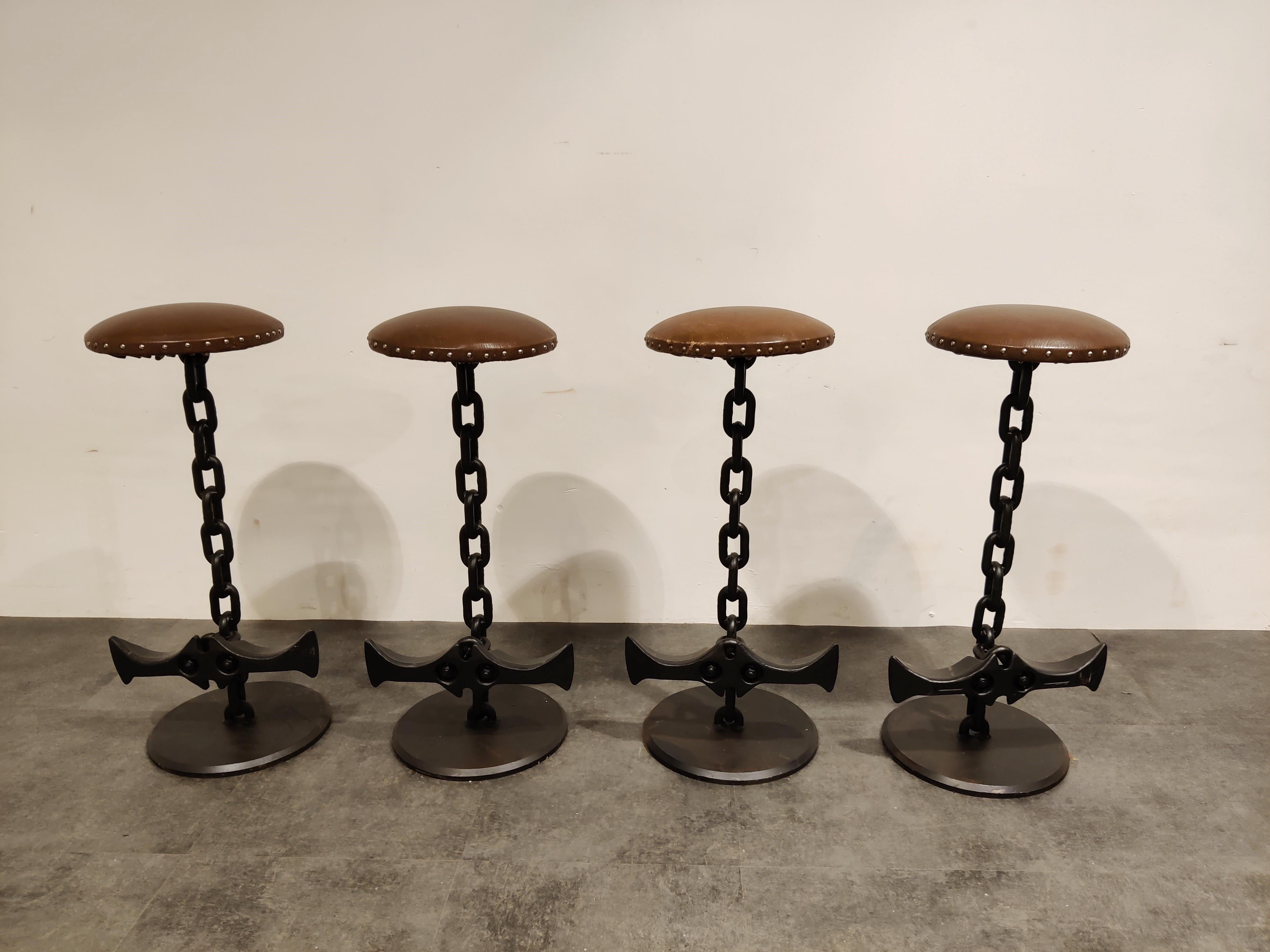 Inventive Brutalist bar stools made from solid metal chain links and brown leather seats.

Needless to say, these bar stools are very robuste and have a nice industrial look to them.

They are made from chains which where used in coal mines, the