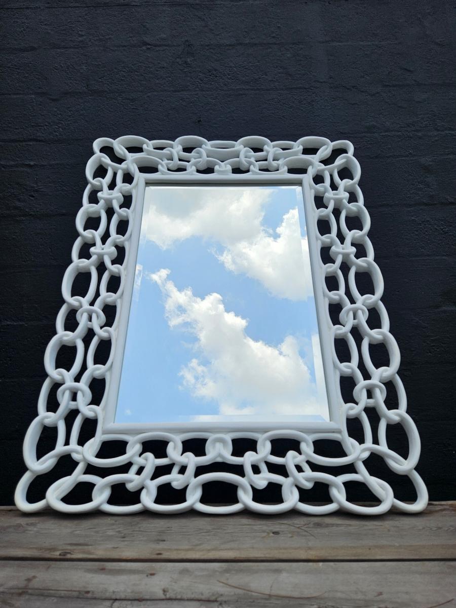 Decorative beveled mirror in a plaster white finished chain link style frame.   The mirror measures 32’ x 48” and has been professionally refinished in plaster white.  The back of the mirror has been replaced with plywood to protect the integrity of