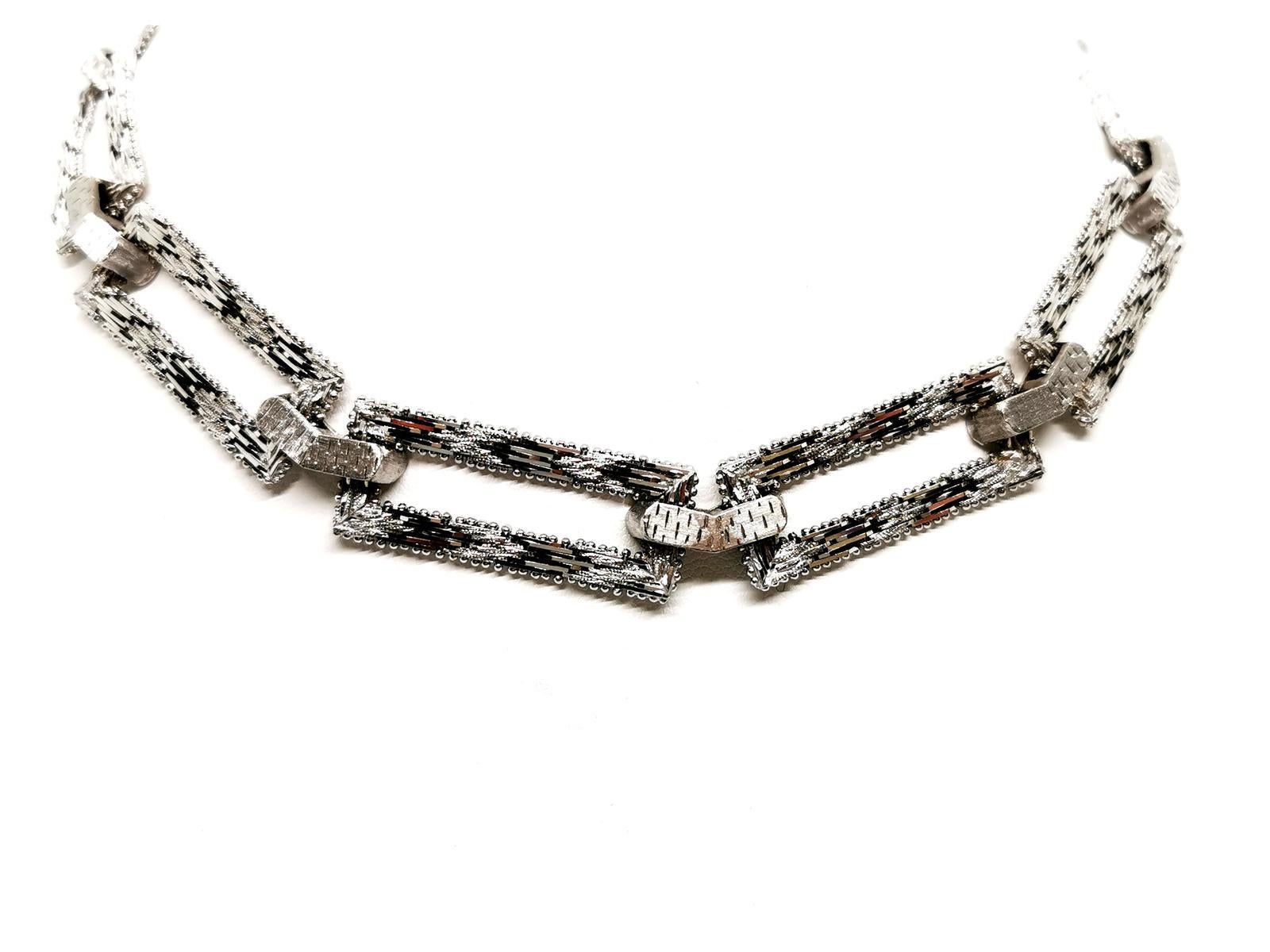 Necklace art deco. white gold 750 mils (18K). composed of 10 rectangular flexible links. worked in matt or shiny. length: 40 cm. width: 1.4 cm. rectangular patterns dimensions: 3.4 cm x 1.4 cm. with eight safety clasp. total weight: 90.29 g. punch
