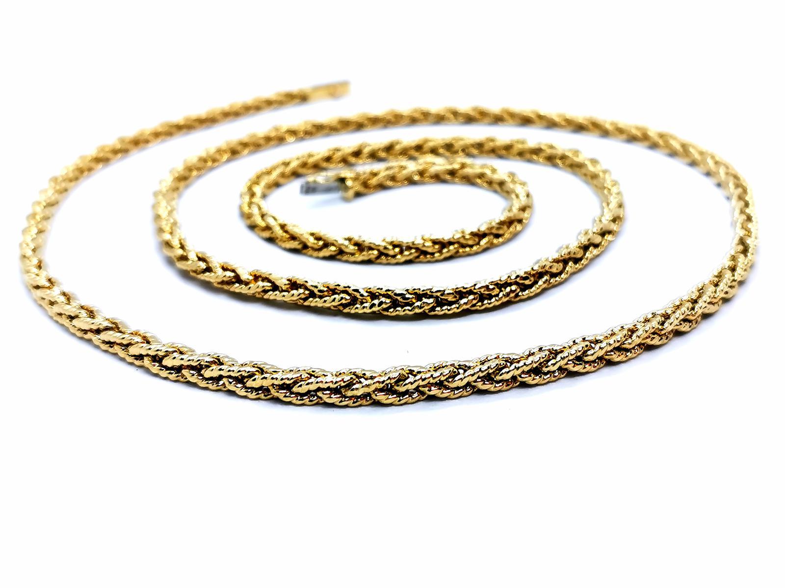 Long necklace. golden yellow 750 mils (18 carats). pretty mesh worked. twisted and braided. length: 81 cm. width: 0.38 cm. with eight safety clasp. total weight: 62.21 g. punched. Excellent state
