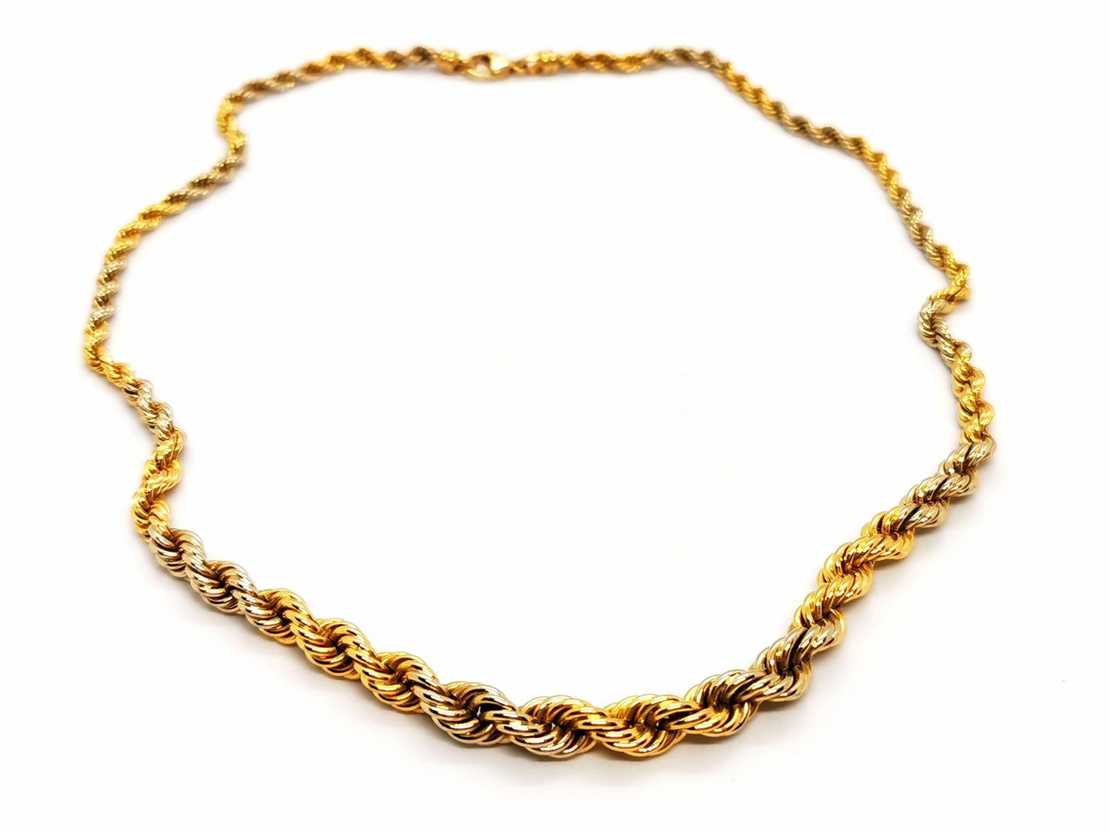 Bi-colored necklace. in yellow gold and white gold 750 thousandths (18 carats). twisted mesh. falling. length: 46 cm. width: 0.48 cm. total weight: 18.46g. eagle head hallmark. excellent condition.
