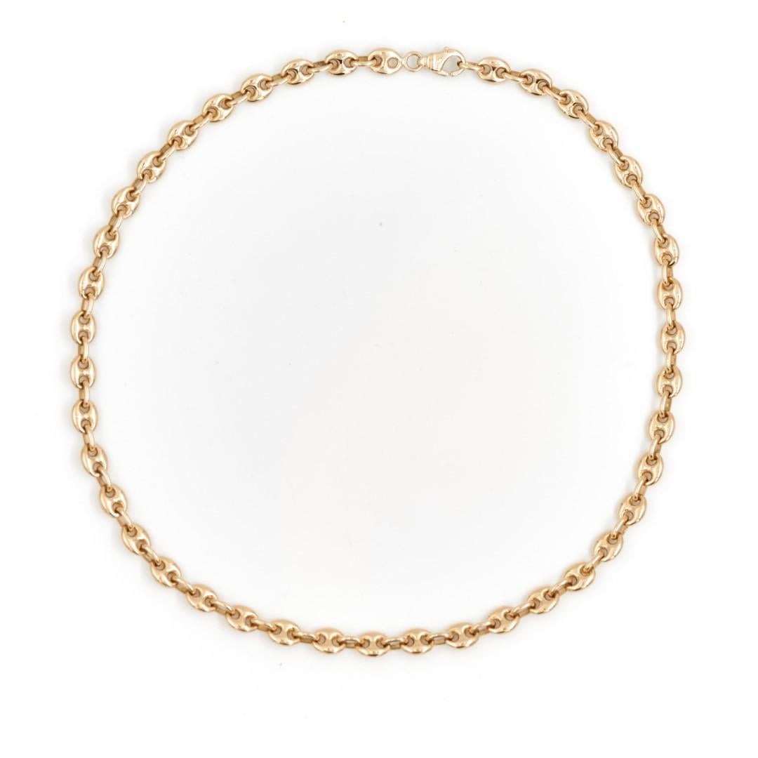 Necklace in yellow gold 750 thousandths (18 carats). mesh coffee bean. length: 39 cm. width of the mesh: 0.59 cm. dimensions of a motif: 0.7 x 0.59. total weight: 35.37 g. eagle head pearl. excellent condition
