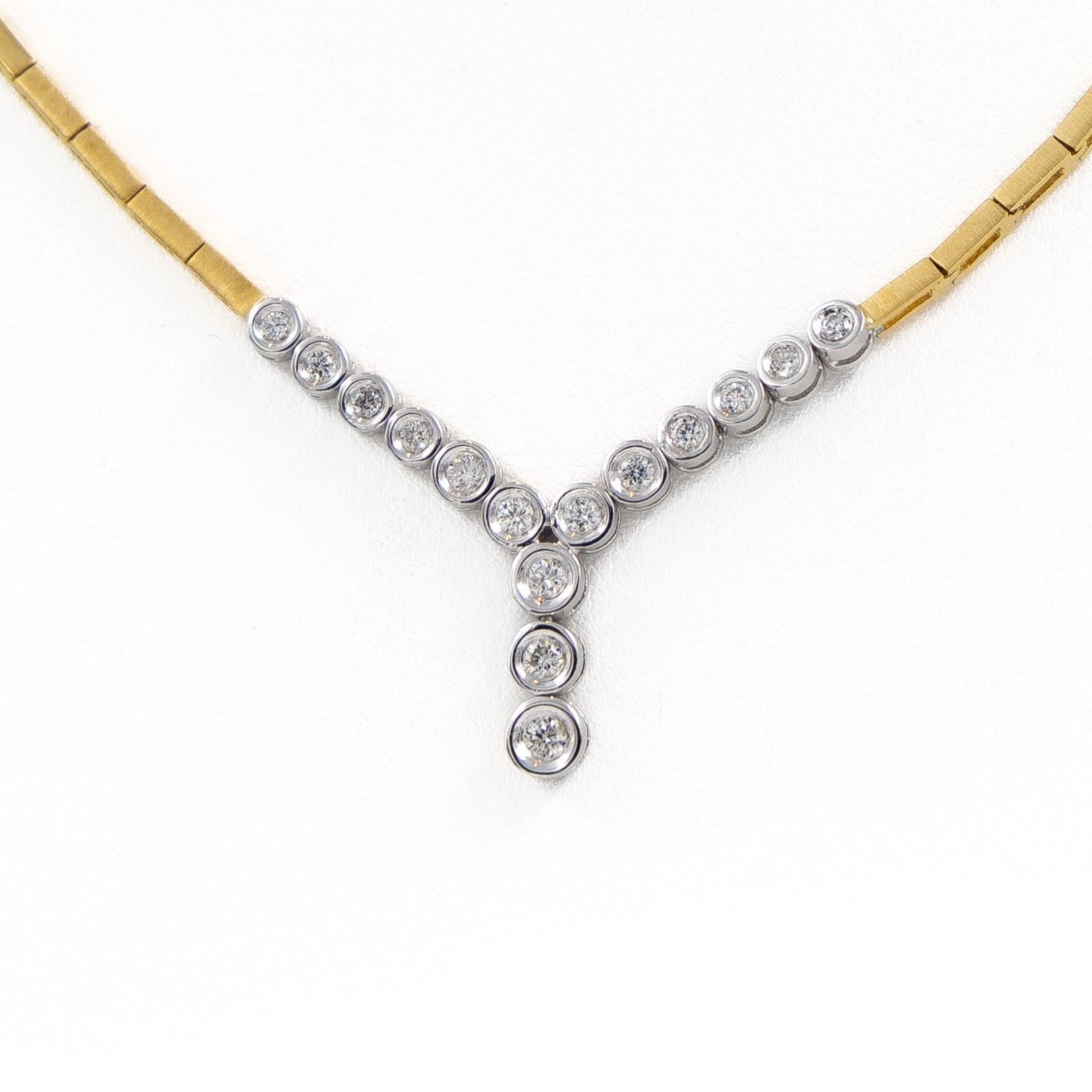 Necklace in yellow and white gold 750 thousandths (18 carats). set with 15 diamonds. brilliant cut. one around 0.07 ct. 2 around 0.05 ct each. 4 around 0.05 ct each and 8 around 0.02 ct. Total weight of diamonds: 0.55 ct. Length of the necklace: 44
