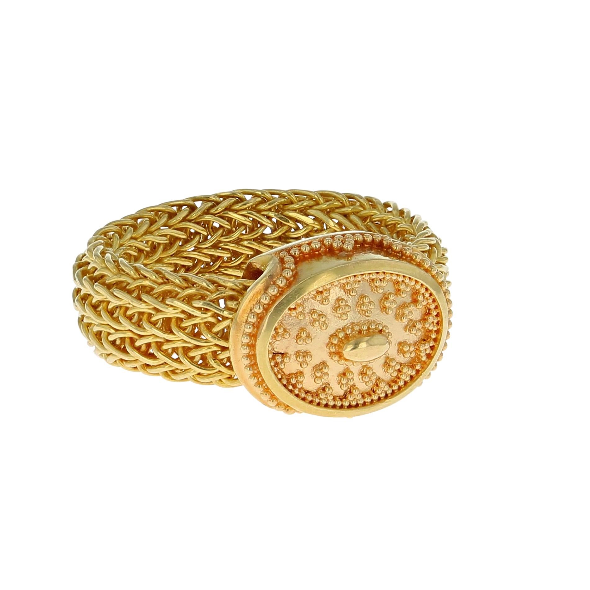 A unique ring from the Kent Raible 'Studio Collection'! This ring features the Raible classic gold granulation, but uses a flexible mesh, hand woven chain band!

Unlike much “designer” jewelry made today, all jewelry work is done under Kent's direct