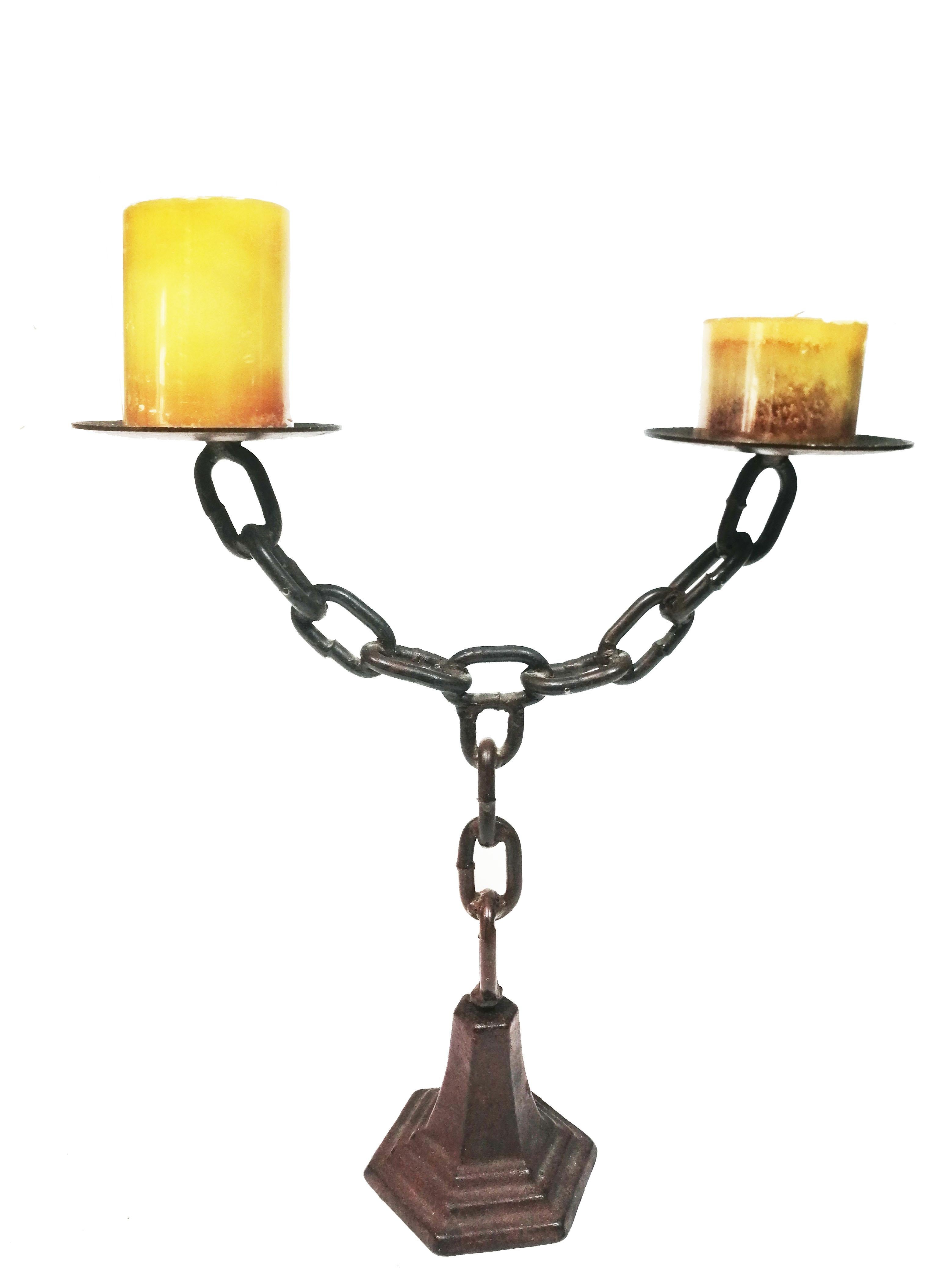 Chain shaped iron candlestick for two candles.

Beautiful medieval-looking chandelier
Spectacular condellabro or candle holder for two large candles

It is made of wrought iron, in the shape of a chain and with two arms

