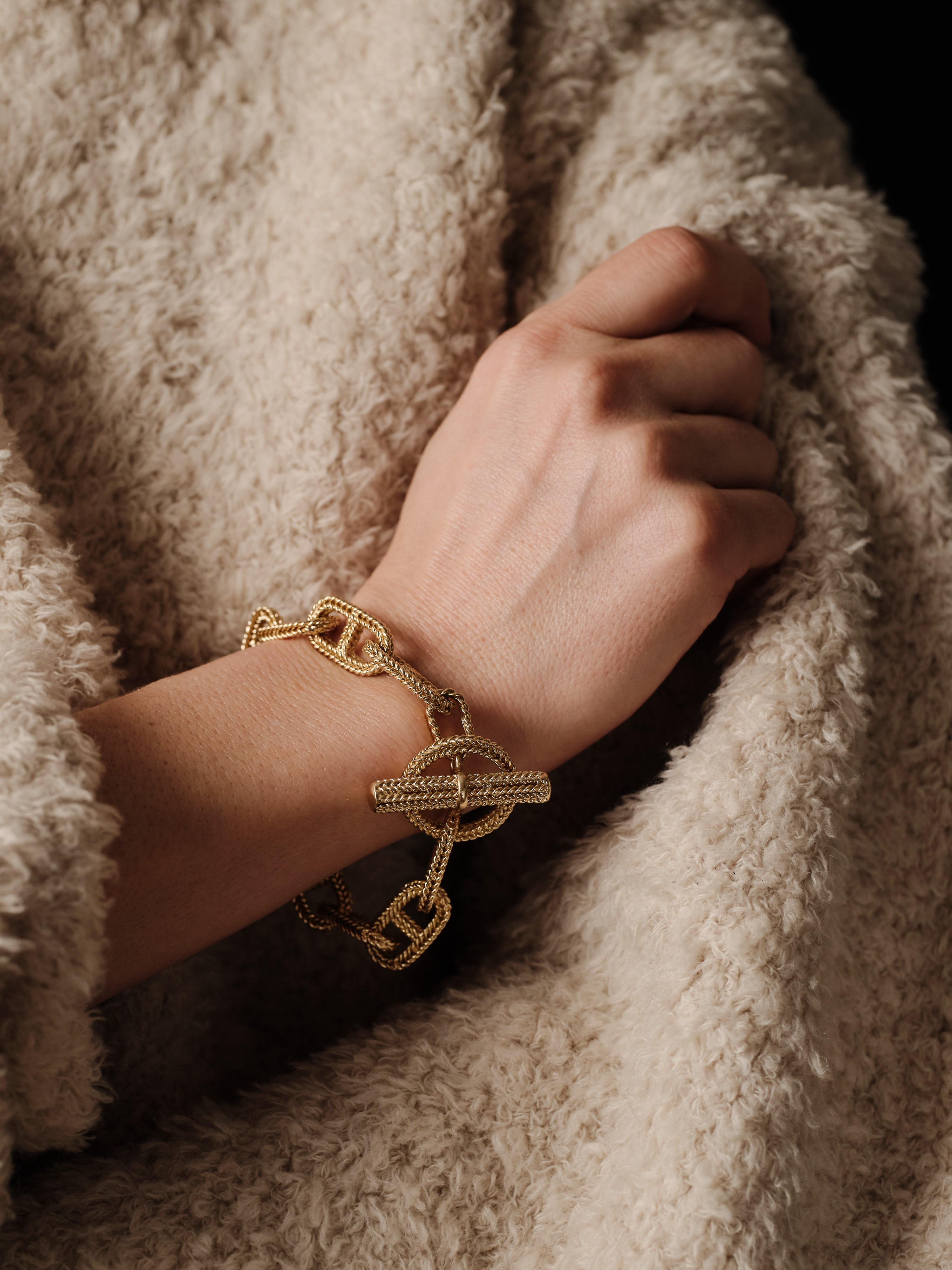 An 18kt gold iconic braided marine mesh Chaine d’Ancre bracelet, with toggle clasp.

The design, first introduced by Hermès in the early 1930s, was inspired by anchor chains used on ships, which serve as a symbol of strength and stability. A