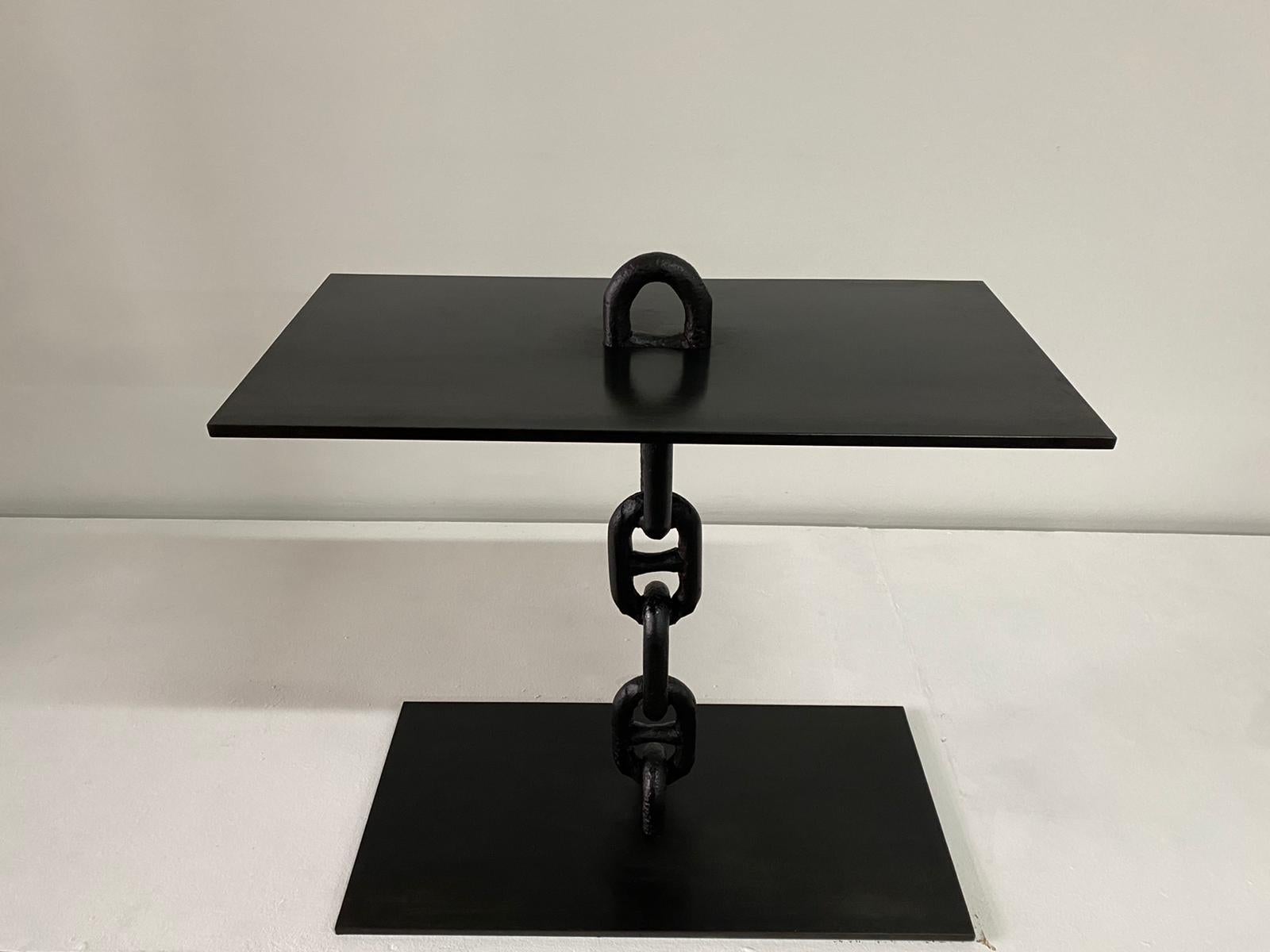 This custom design console is one-of-a-kind, only one made since antique chain links of this scale are rare. This is solid and heavy, finished in a blackened wax finish. Can be used indoors or outdoors. This console can be affixed to a wall with 2