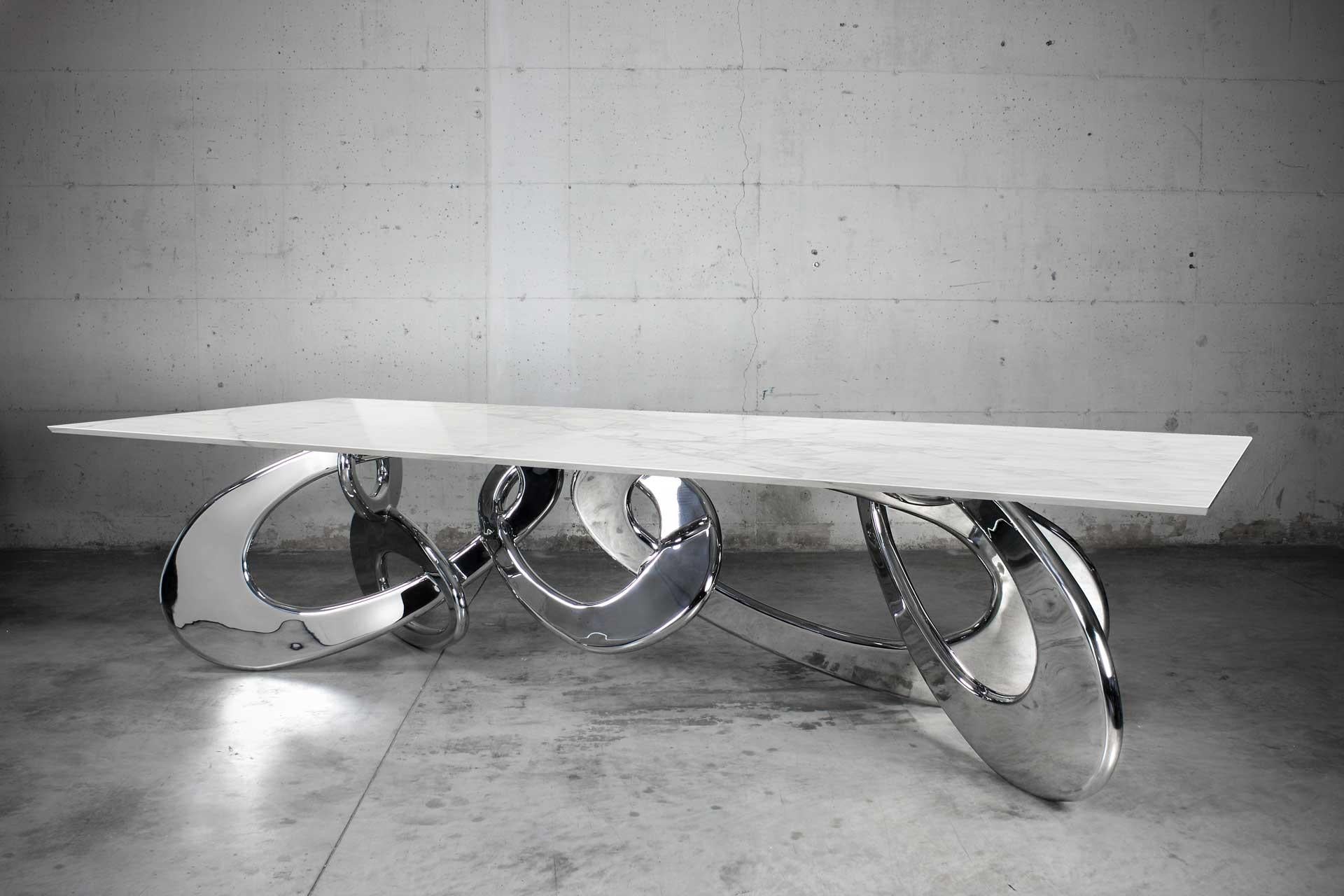 Chained Up Miami Dining Table by Barberini & Gunnell
Limited Edition of 6
Dimensions: D 120 x W 320 x H 76 cm.
Materials: Calacatta marble, mirror polished stainless steel.

The inspiration for this table came from observing the gigantic iron chains