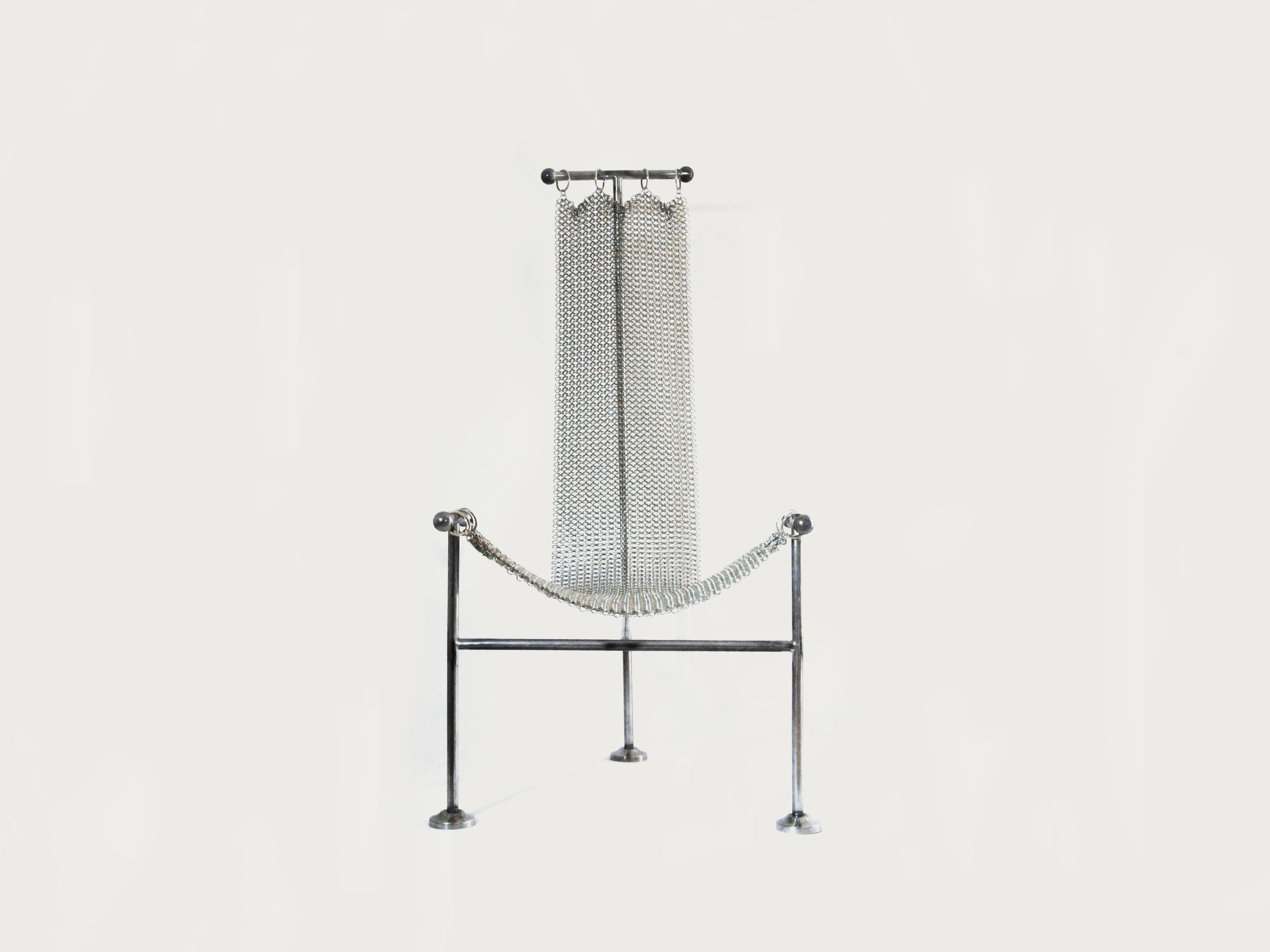 Chainmail chair is a new take on William Katavolos 1952’s T-chair. Its seat is made up of hand-linked metal rings coming together to form a strong and flexible mesh that drapes down its T structure.
For Chainmail chair we sought to create a design