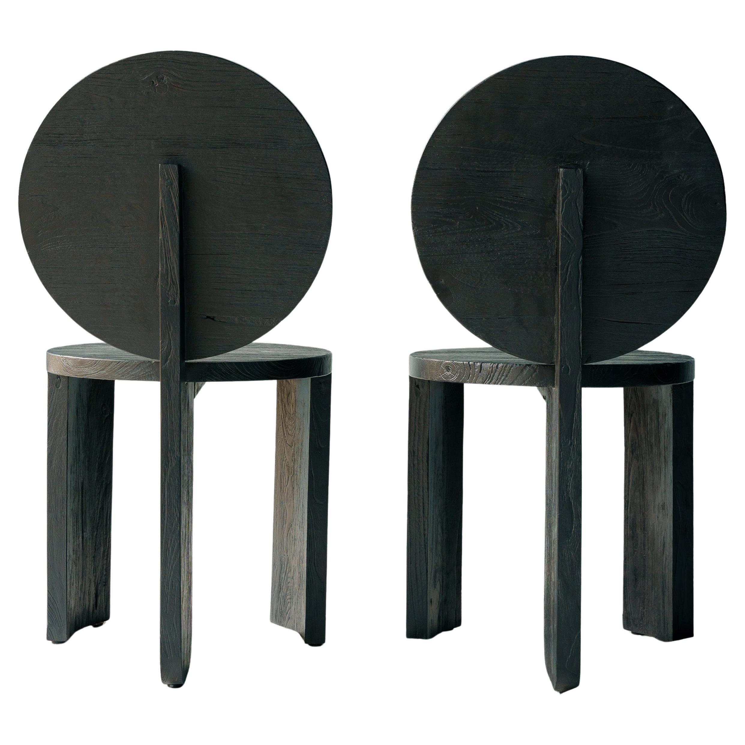 Chair 00 is a bold statement of simplicity and strength, crafted entirely from wood with a refined, architectural design. The circular backrest is a striking focal point, offering both structural elegance and a sense of completeness. Its clean lines