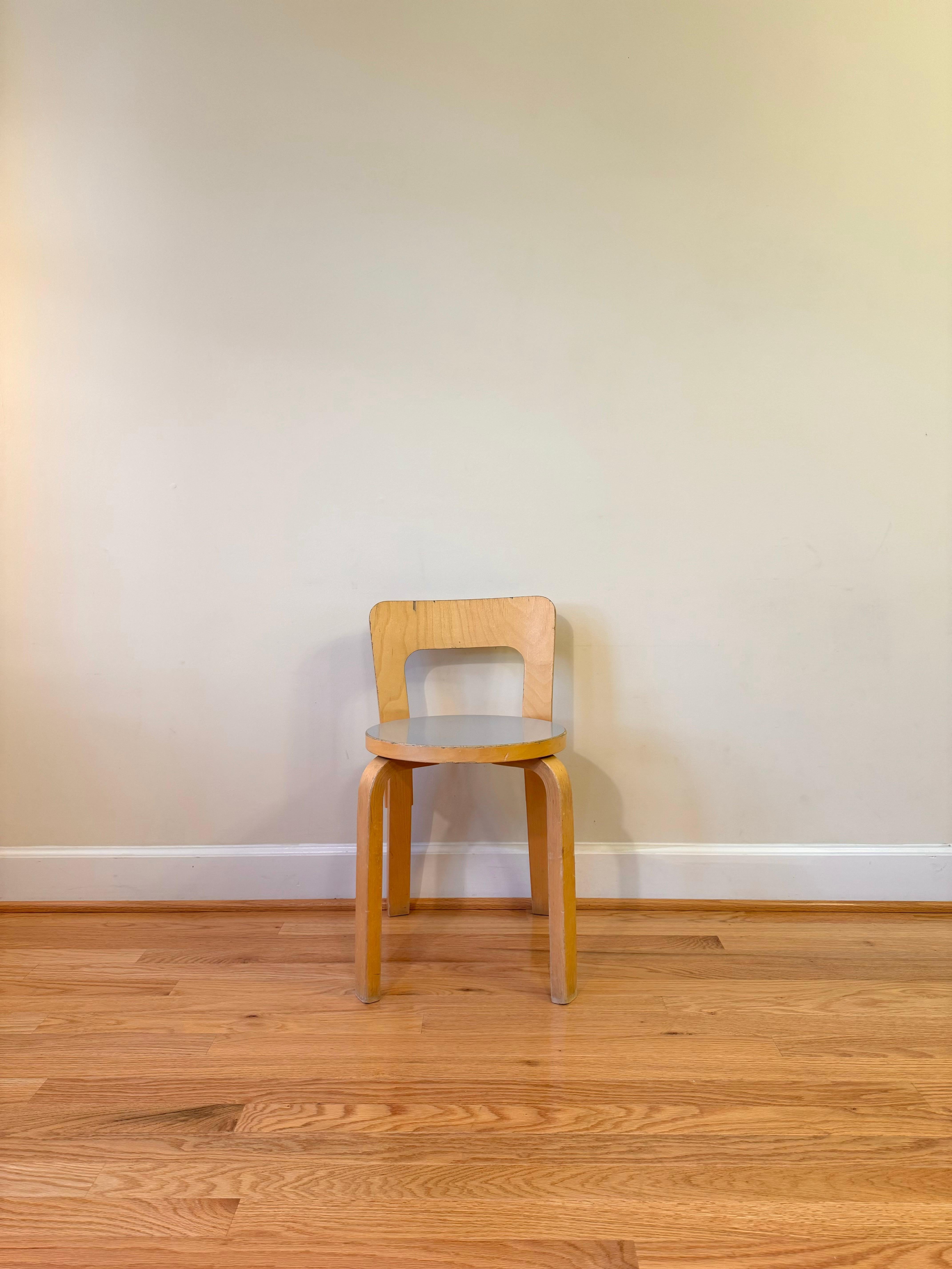 Clean lines and a simple structure define the design of Chair 65. 

A low, rectangular backrest is formed from a single piece of birch plywood and has a slight curve that forms naturally to the back, offering comfort and support. 

The height of the