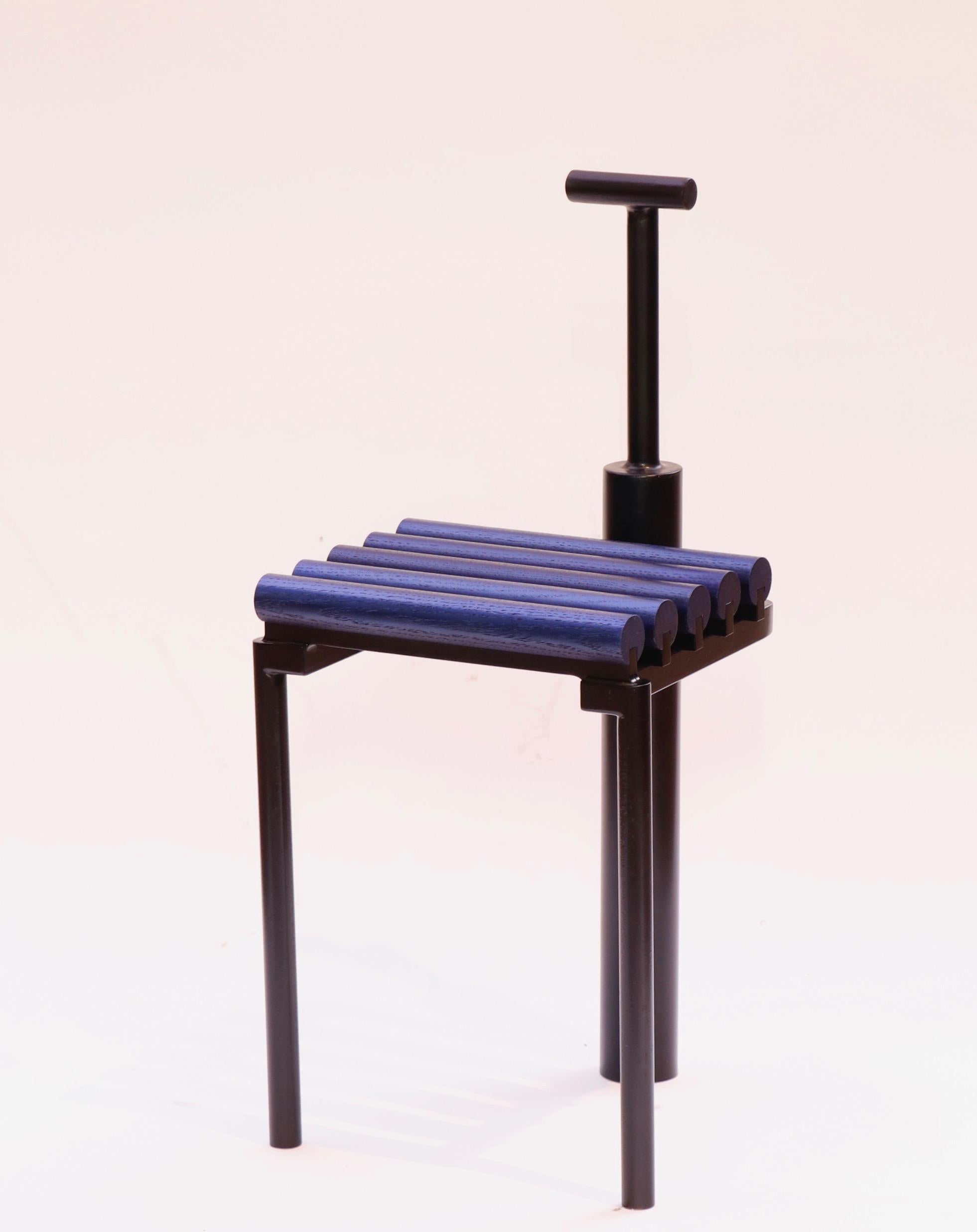 Statement chair fabricated from steel and white oak. Steel is coated with black epoxy paint, oak is coated with metallic blue paint. Chair is small, meant to be sculptural but functional. Steel is carefully fabricated inspired by metal castings,