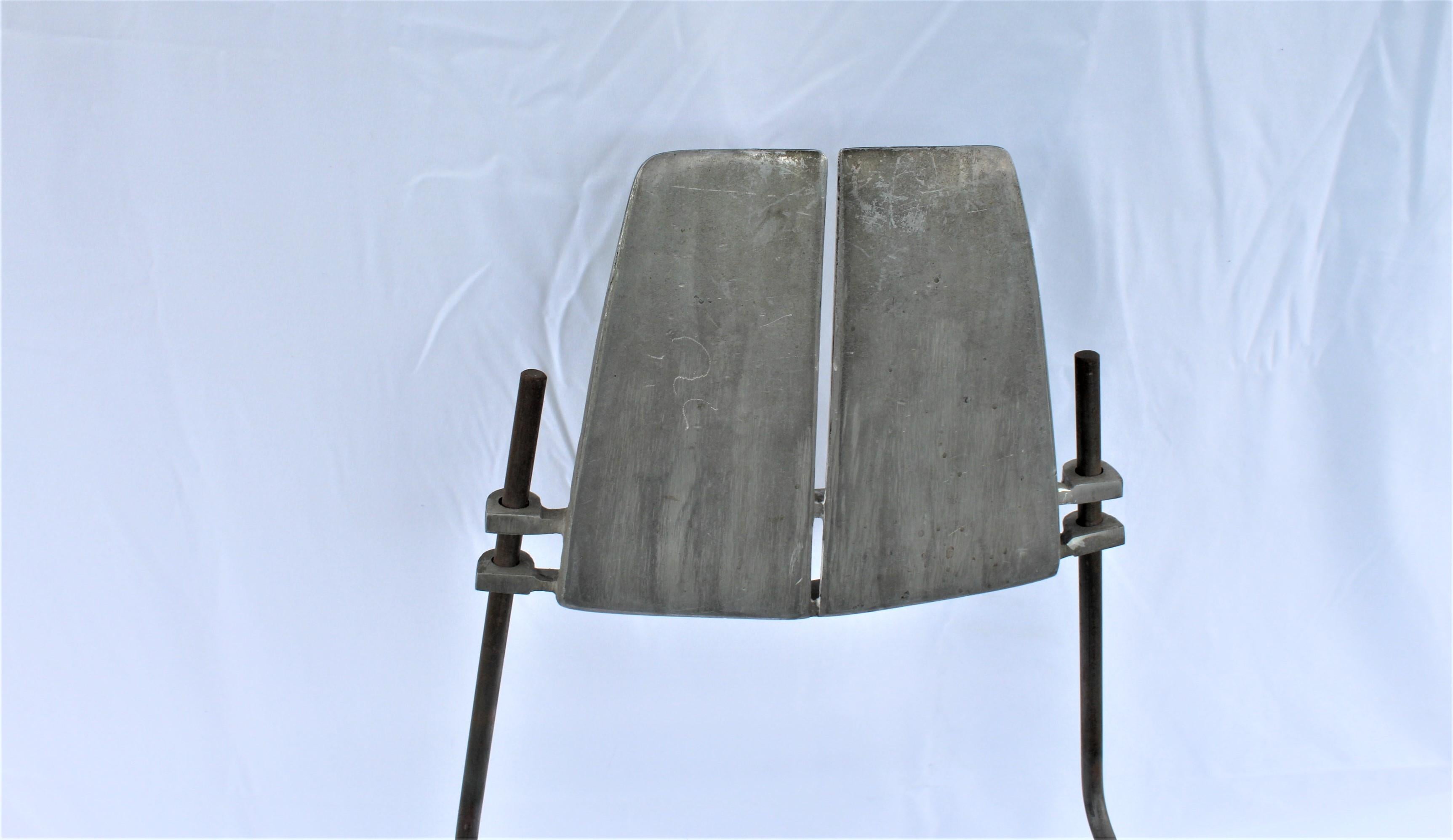 A unique type of chair. Made for a designer showroom in Los Angeles . This is the showroom sample .Cast aluminum and steel rods make up the puzzle. Only needs a simple wood seat made for it. Designed by R Josten, circa 1970s. Only one.