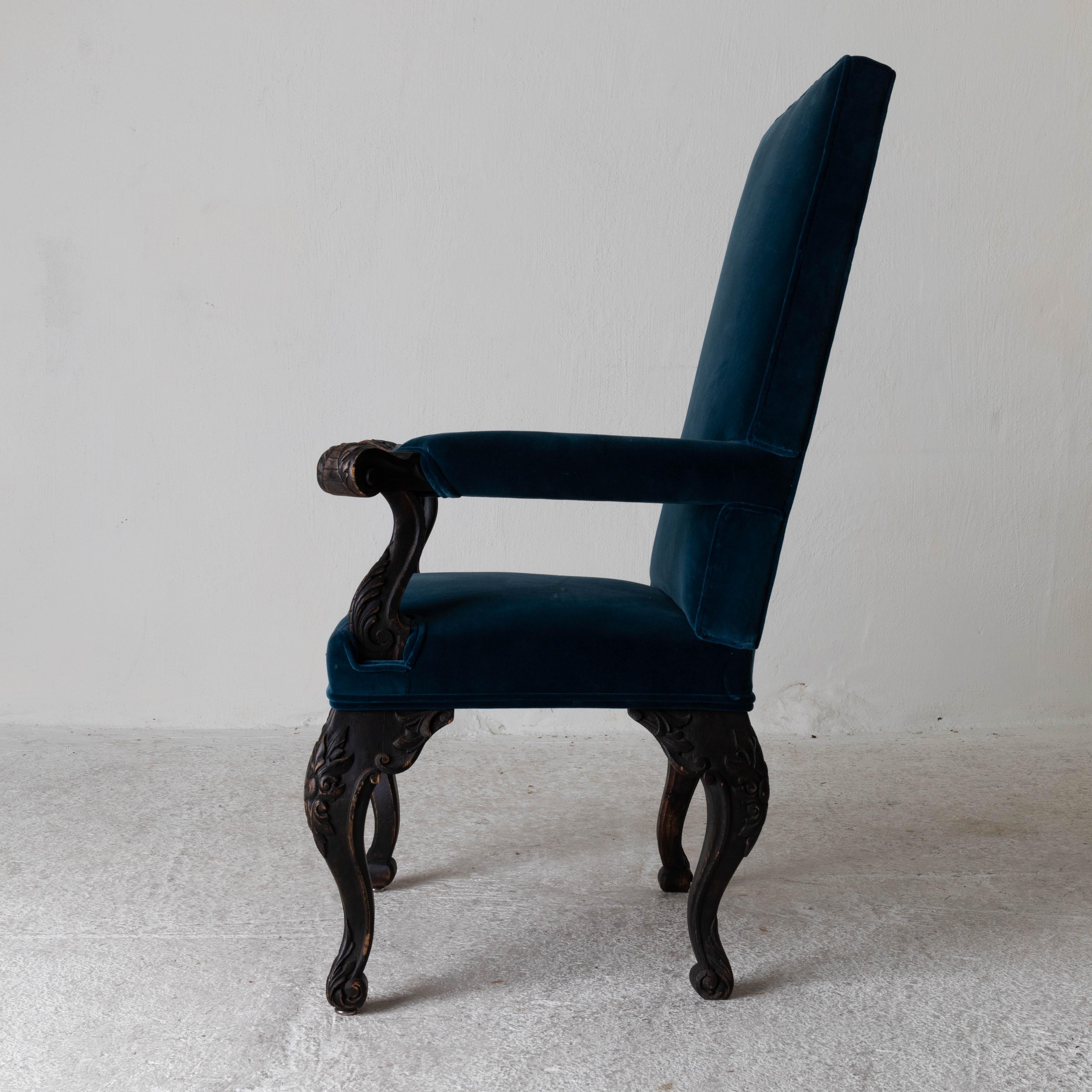 Chair armchair Swedish 19th century black frame blue upholstery Sweden. An armchair made during the 19th century in Sweden. Upholstered in a blue with a green hint cotton velvet. Painted in our Laserow black. Leaf carvings on armrests and legs.

  