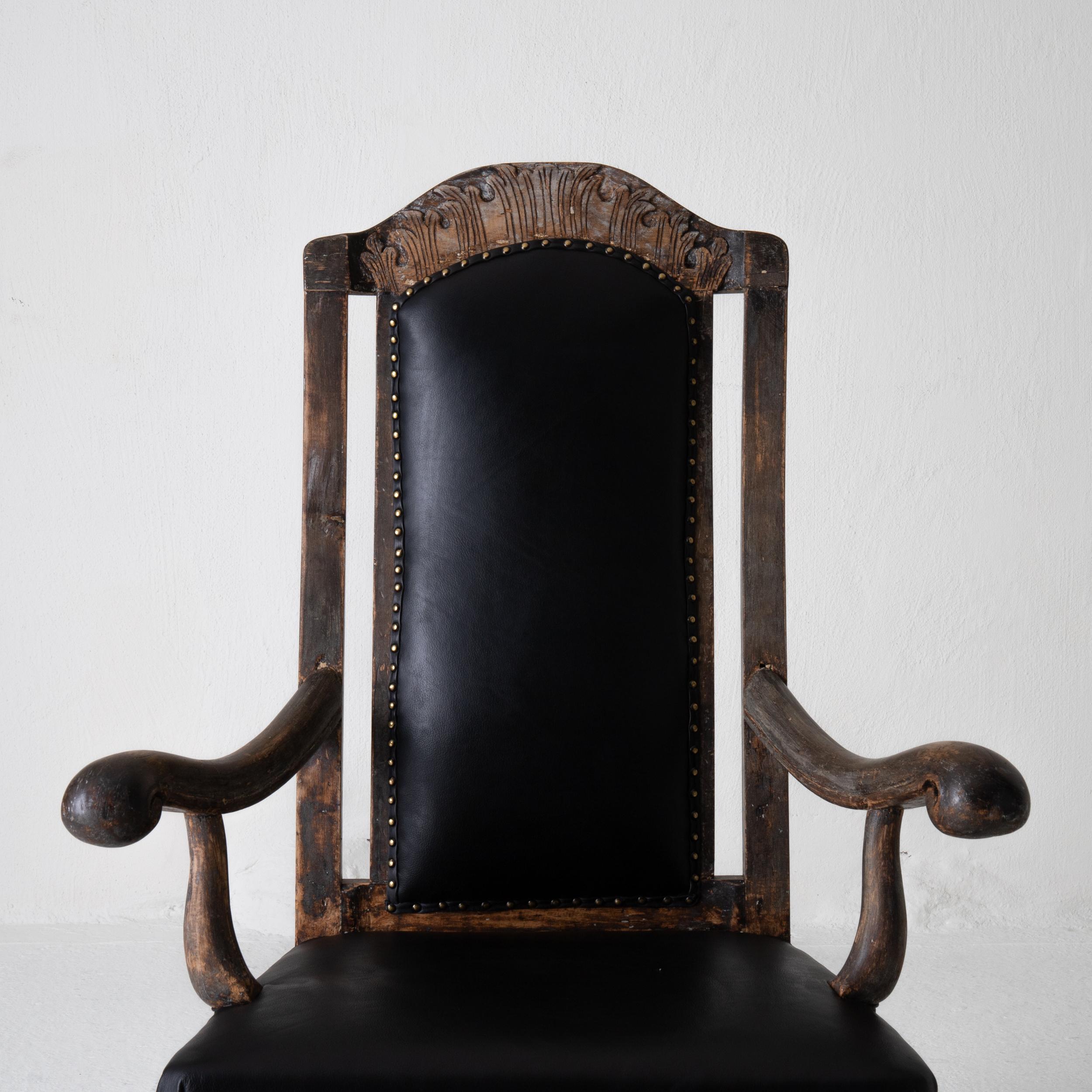 Chair armchair Swedish baroque black original paint, Sweden. An armchair during the baroque period in Sweden in a generous size. Stripped to its original finish with a beautiful leather as upholstery.
 
             