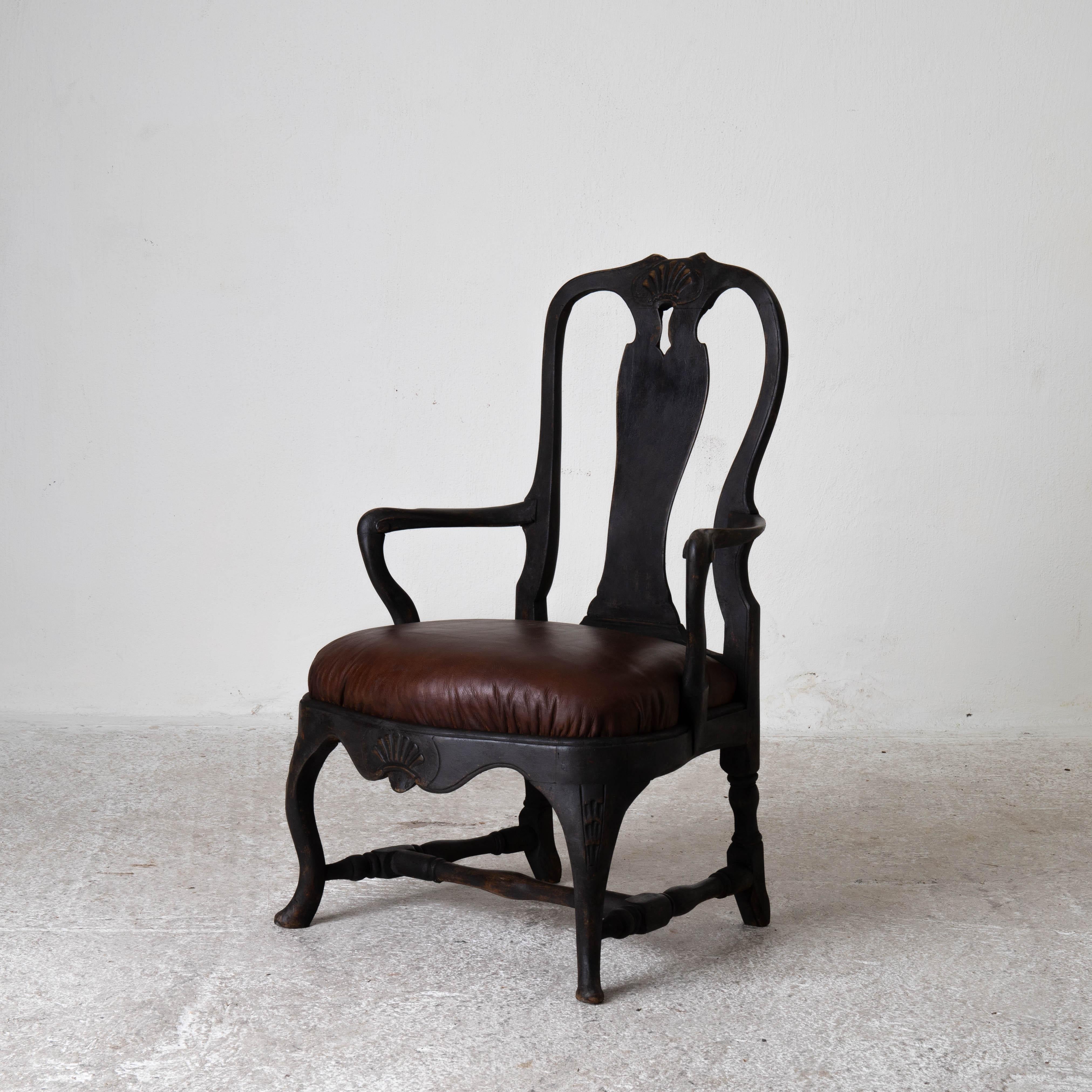 Chair armchair Swedish Rococo 1750-1775 black Sweden. An armchair made during the Rococo period in Sweden 1750-1775. Repainted in our Laserow Black. Seat upholstered in a waxed brown leather.

 