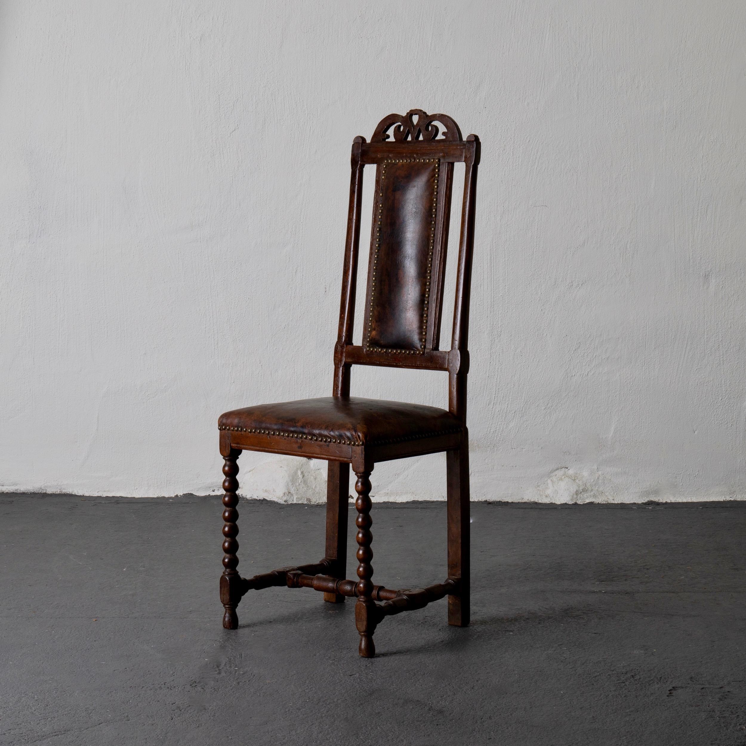 Chair Baroque Swedish brown leather Sweden. A side chair made during the Baroque period in Sweden, 1650-1750. Upholstered in a dark brown leather with brass nailheads. Beautiful patina on both frame and leather.