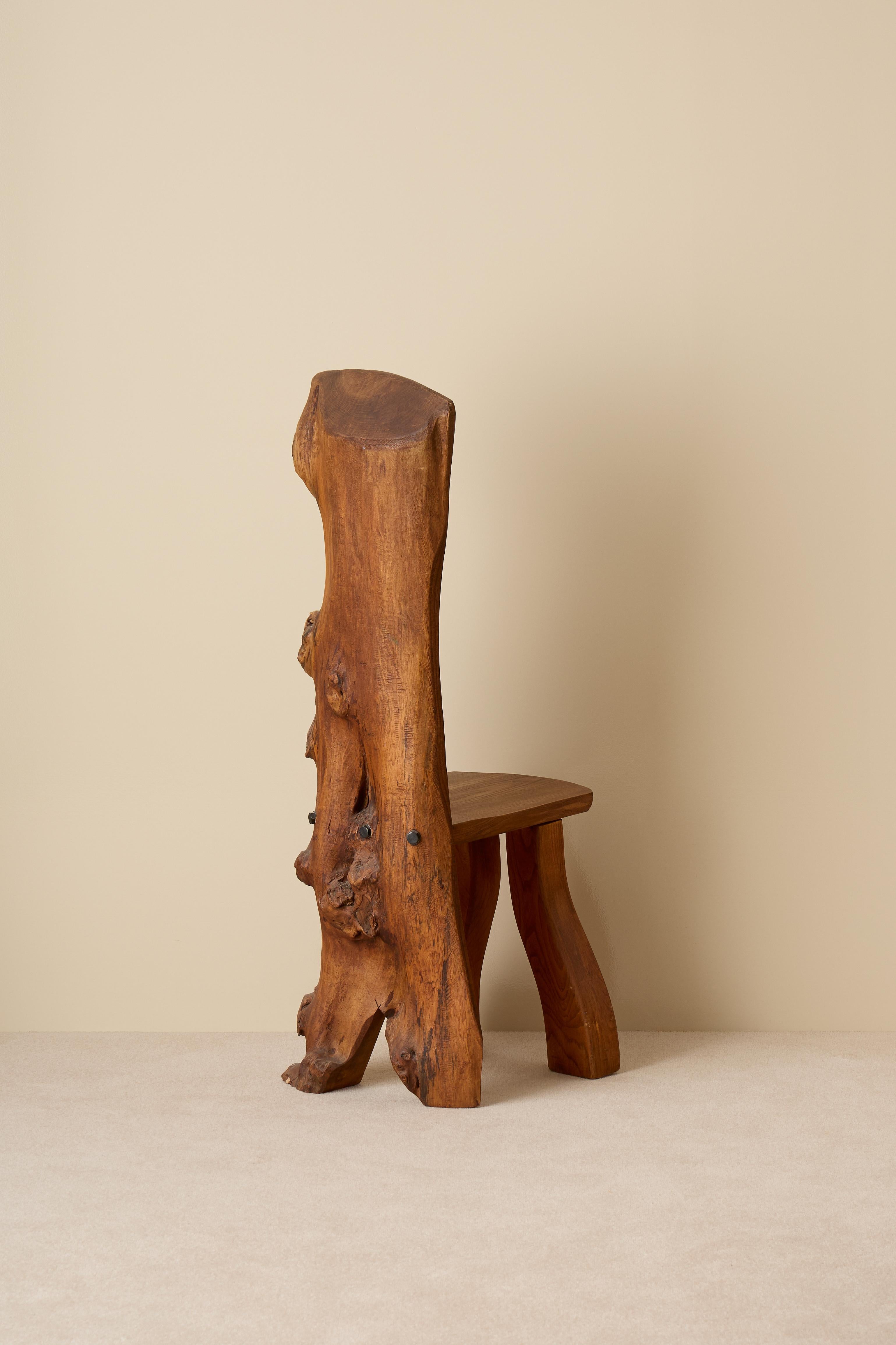 A lovely and rare naturalistic shaped chair in elm. 
Produced by C. A. Beijbom, 1970s, Sweden.