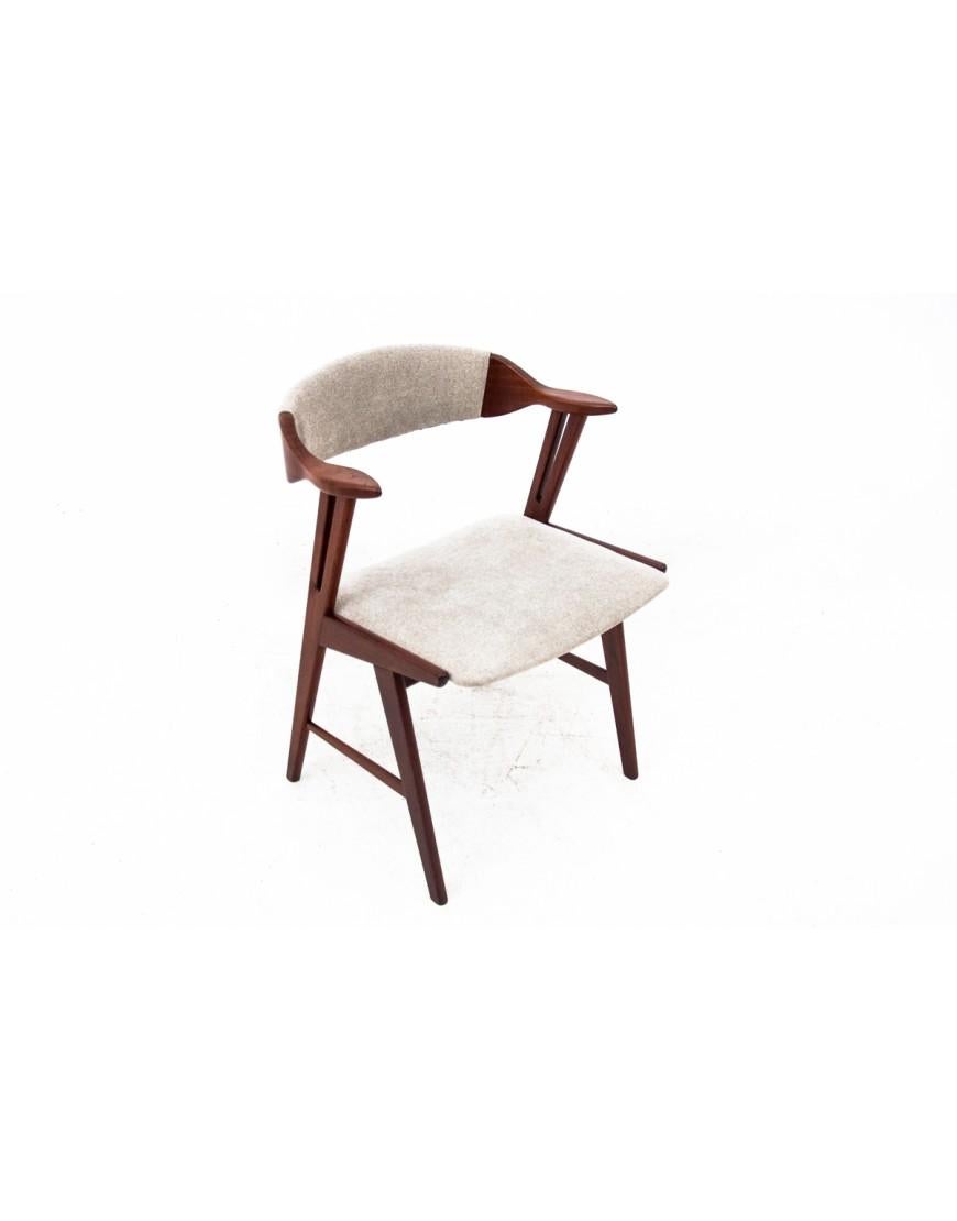 Danish chair from the 1960s.

A chair with a unique form with small armrests and a curved backrest that provides comfortable seating.

Furniture in very good condition, after professional carpentry and upholstery renovation. Cleaned wood, finished