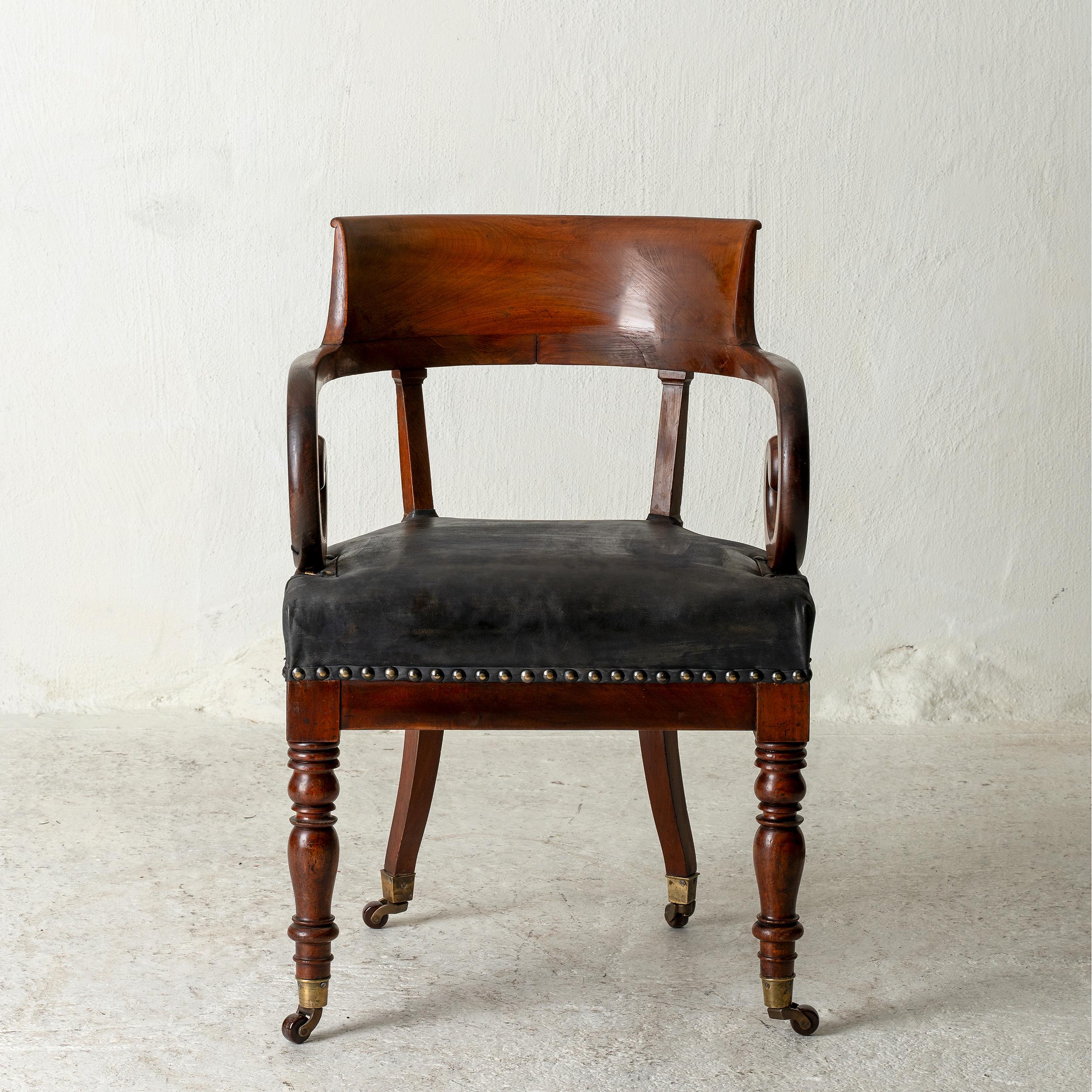 Chair desk Swedish mahogany brown Sweden. Armchair made during the early 19th century in Sweden. Frame made from dark brown mahogany. Curved back and spiral armrests.