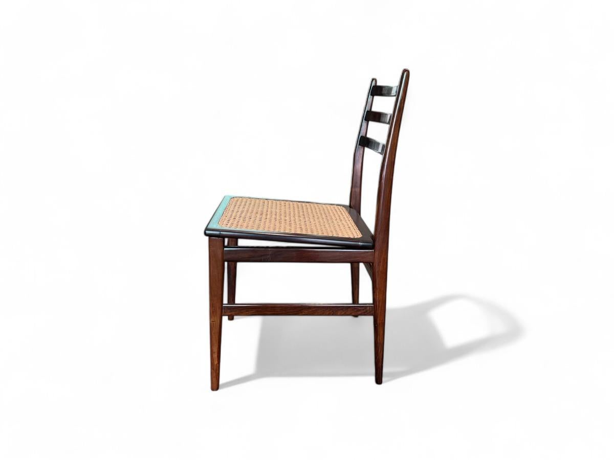 This gorgeous chair features a delicate rosewood (jacaranda) structure with caning in the seat, combining lightweight construction with exceptional sturdiness and durability. Their Brazilian modern style makes them a versatile addition that would
