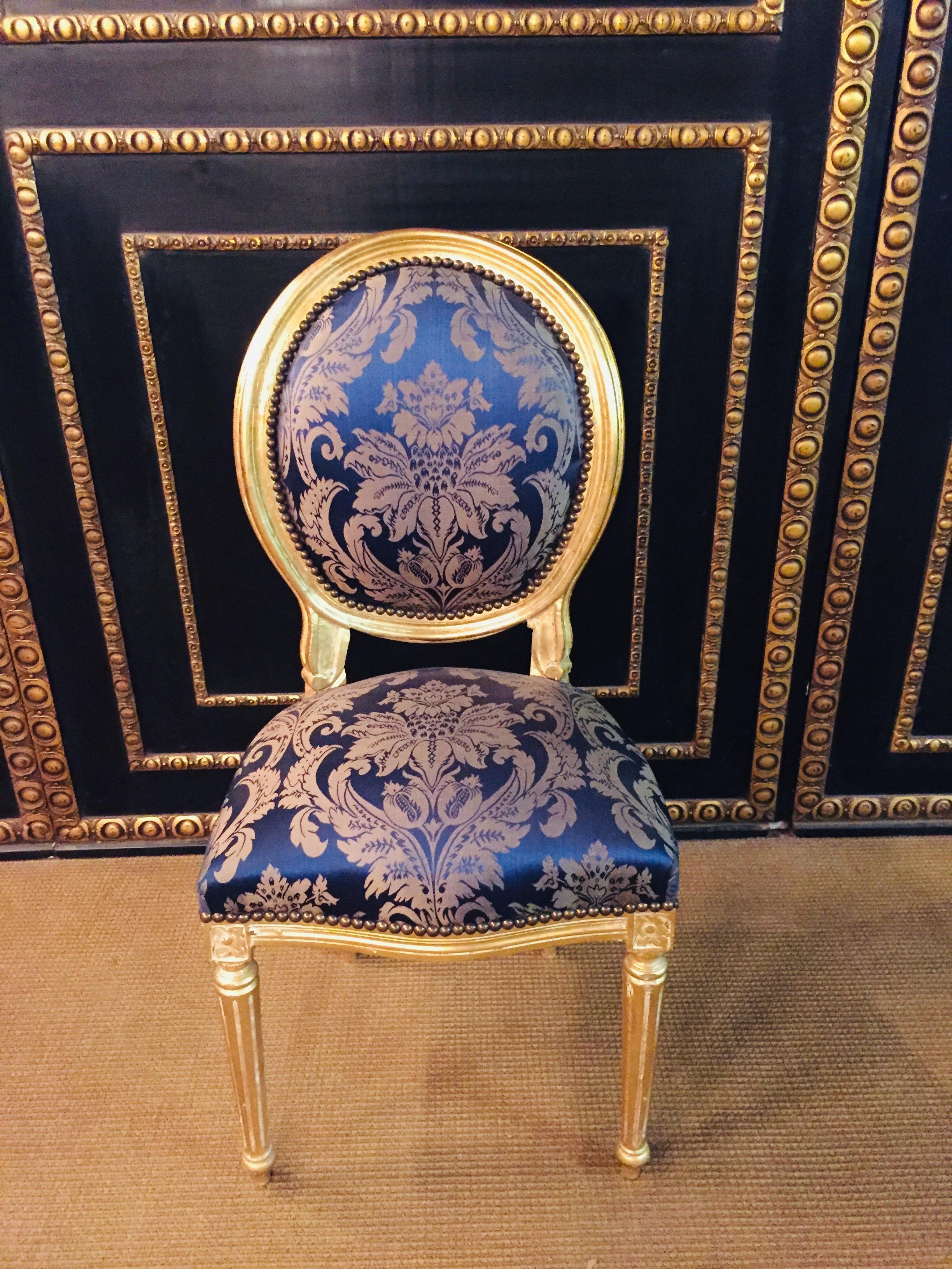Chair in Louis Seize style.
Solid beech wood, set and gilded. Cambered and carved frame on fluted, pointed legs. Curly armrests. Straight supports with applied acanthus leaves.
oval backrest frame.
Seat and backrest are finished with a historic,