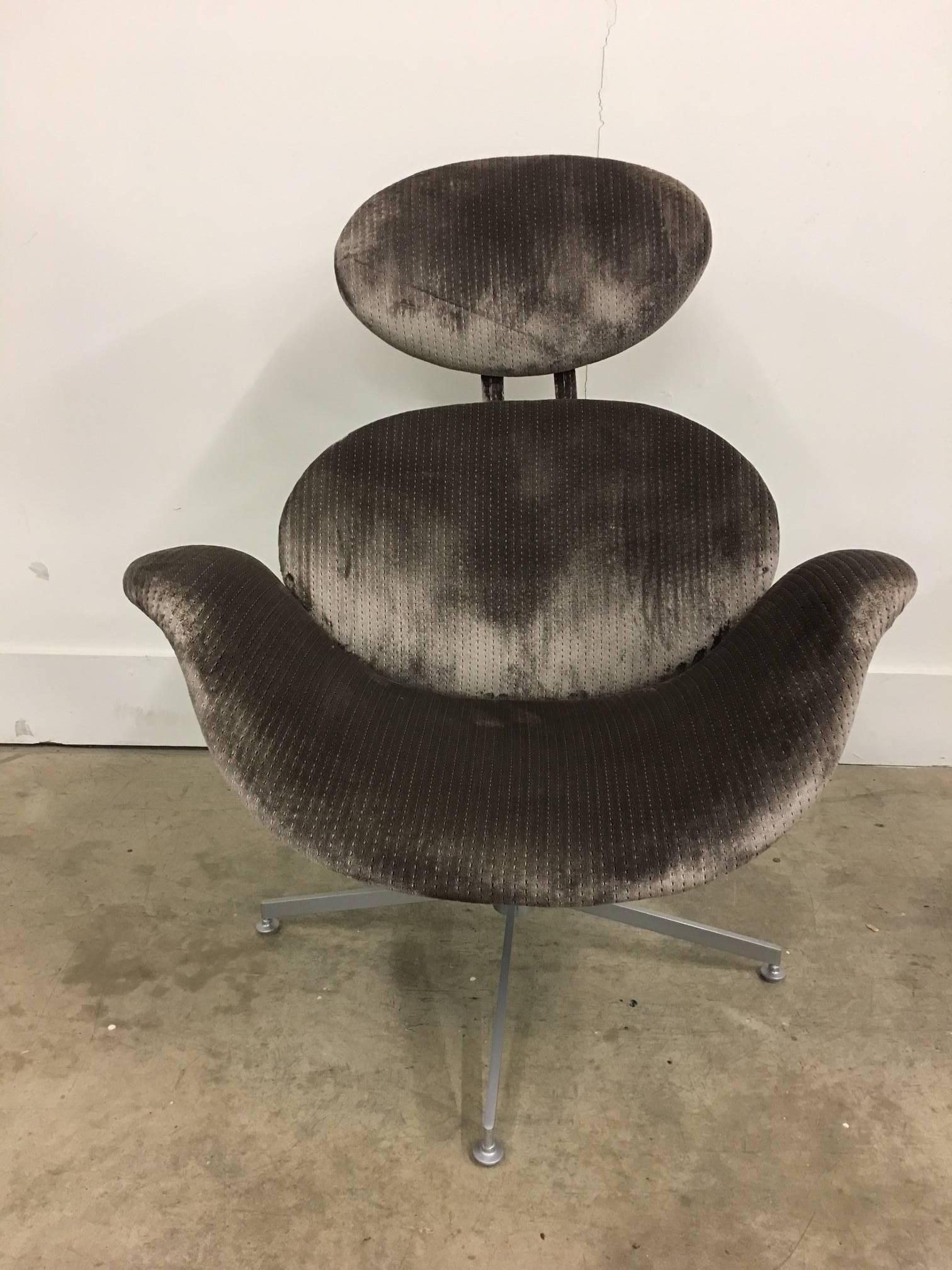 This vintage chair is unmarked, but is in the manner of Arne Jacobsen.  It is a near match to Jacobsen's Swan chair, but with the addition of a headrest.  has just been recovered in luscious Donghia fabric.  The swivel base has been smoothed and