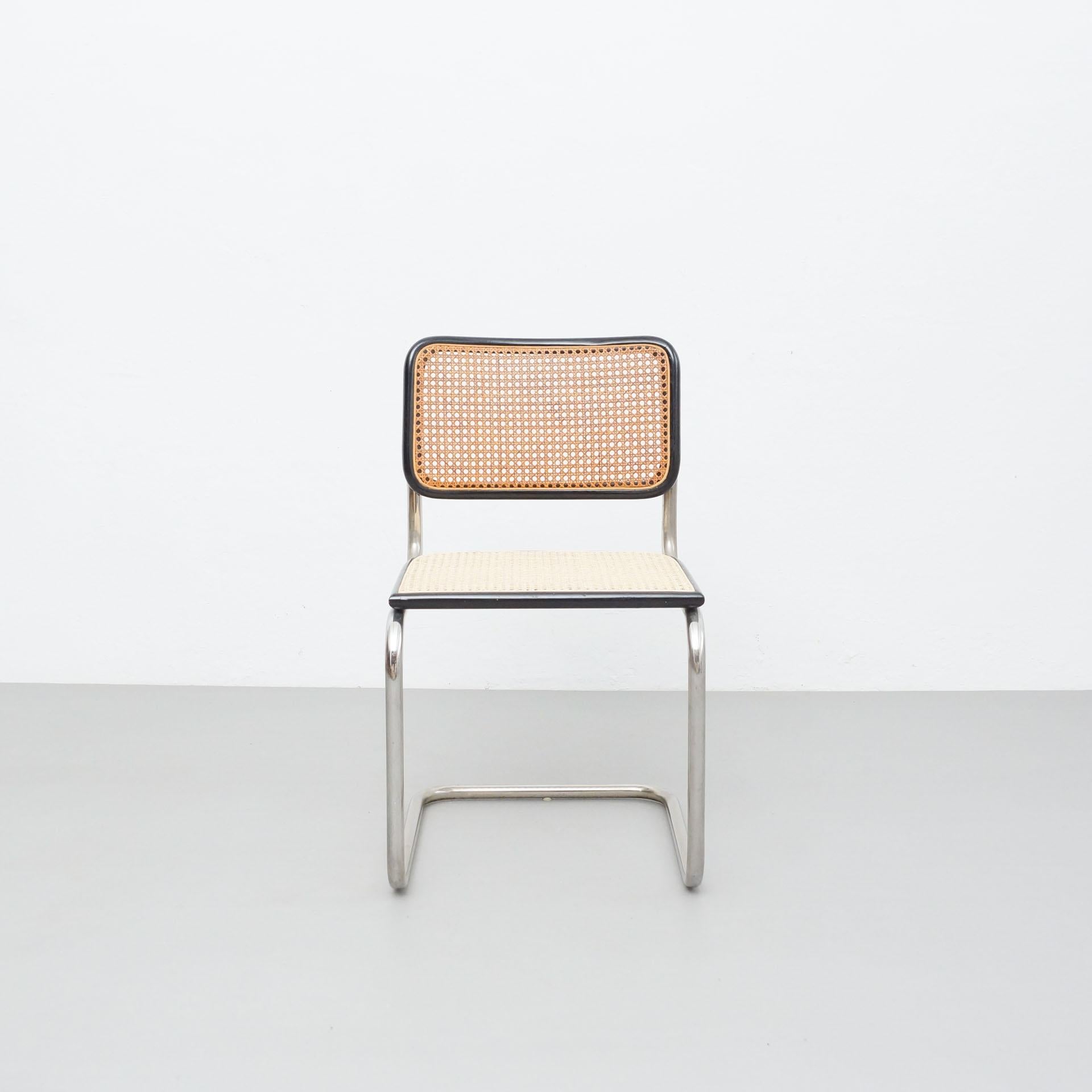 Chair designed in the style of Marcel Breuer, by unknown manufacturer from France.

In original condition, with minor wear consistent with age and use, preserving a beautiful patina.

Materials:
Wood
Rattan
Steel

Dimensions:
 D 54 cm x W