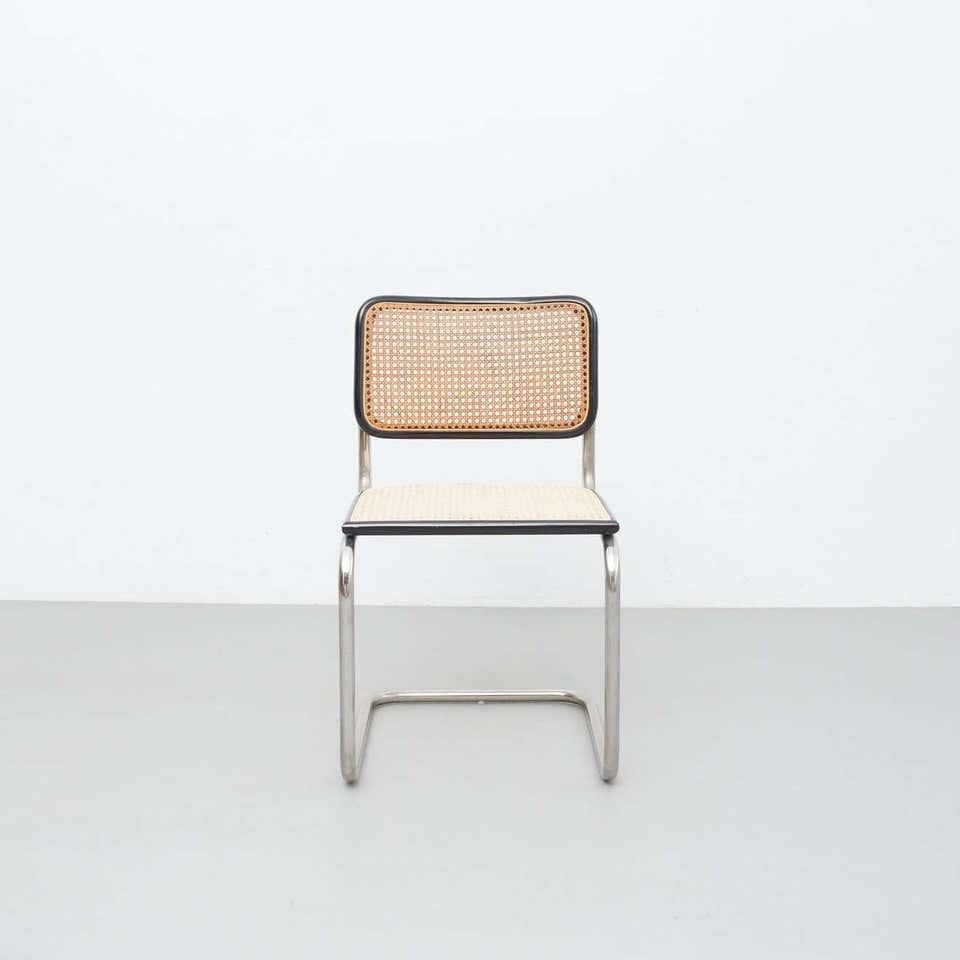 Chair designed in the style of Marcel Breuer, by unknown manufacturer from France.

In original condition, with minor wear consistent with age and use, preserving a beautiful patina.

Materials:
Wood
Rattan
Steel

Dimensions:
 D 54 cm x W 46.5 cm x