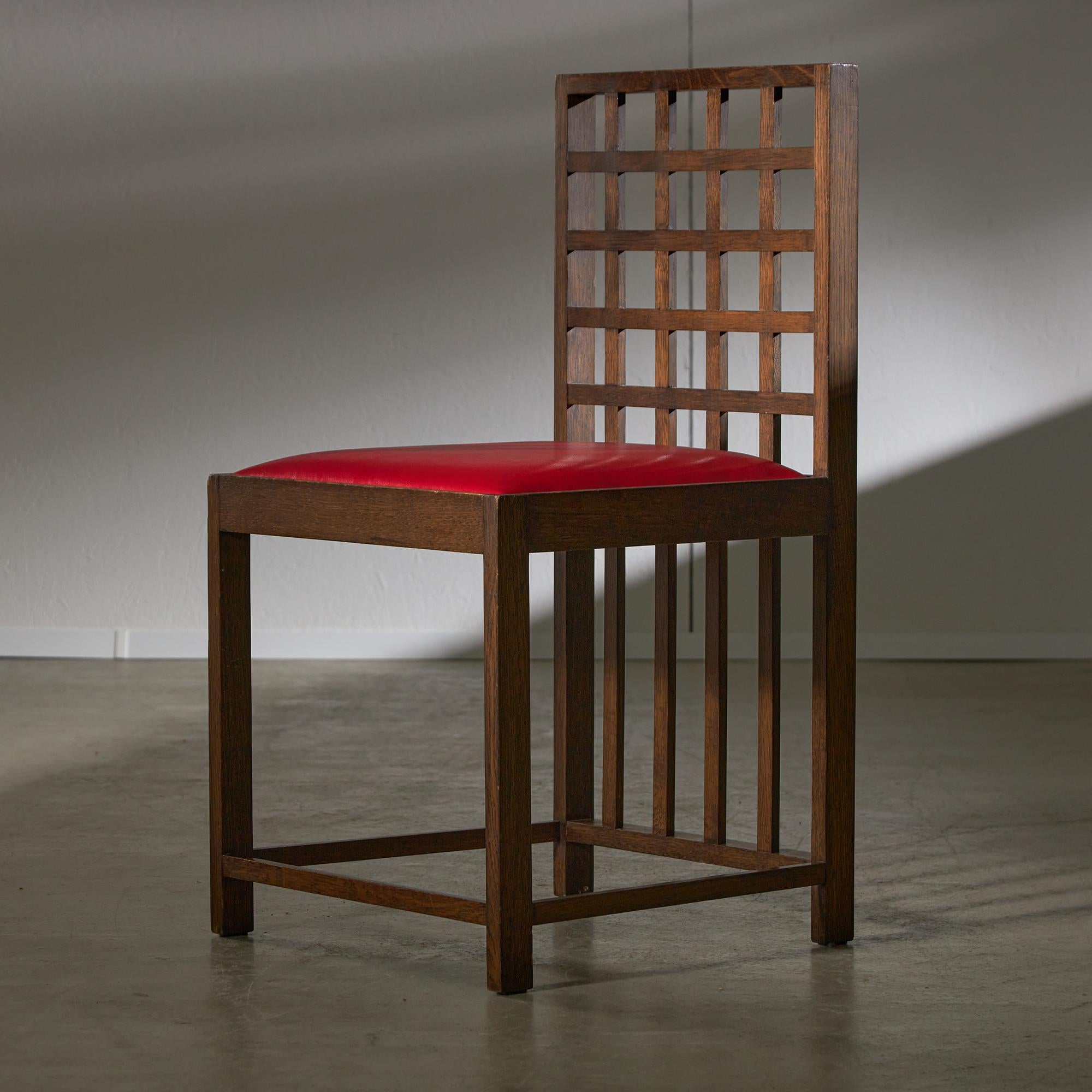 Experience the elegance of minimalism enhanced by a striking red accent. This chair embodies a harmonious balance between simplicity and innovation, drawing inspiration from a Charles Rennie Mackintosh pattern. The meticulous combination of wood and