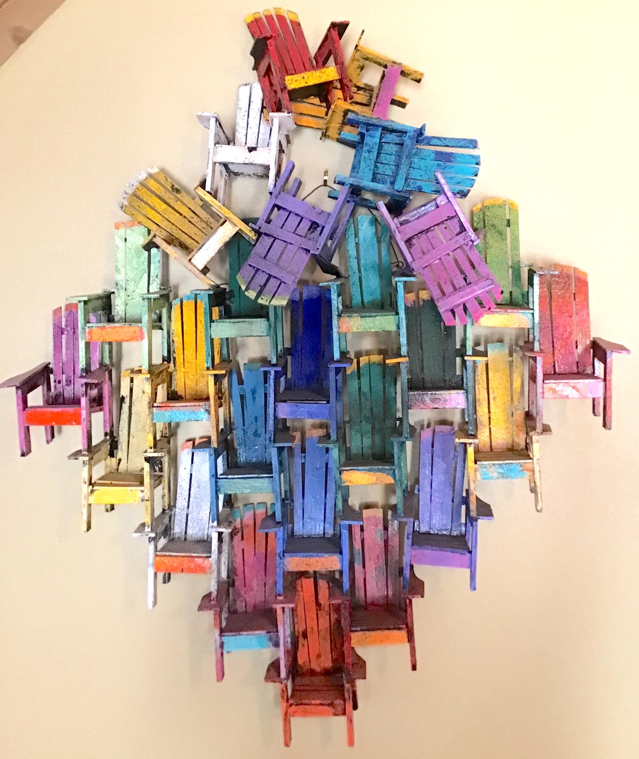 Colorful Adirondack chair wall sculpture

Paul Jacobsen used everyday objects, such as chairs, cars, airplanes, trains, motorcycles and puzzles, all built from scratch, and turns them into very desirable works of art. Among his most famous works