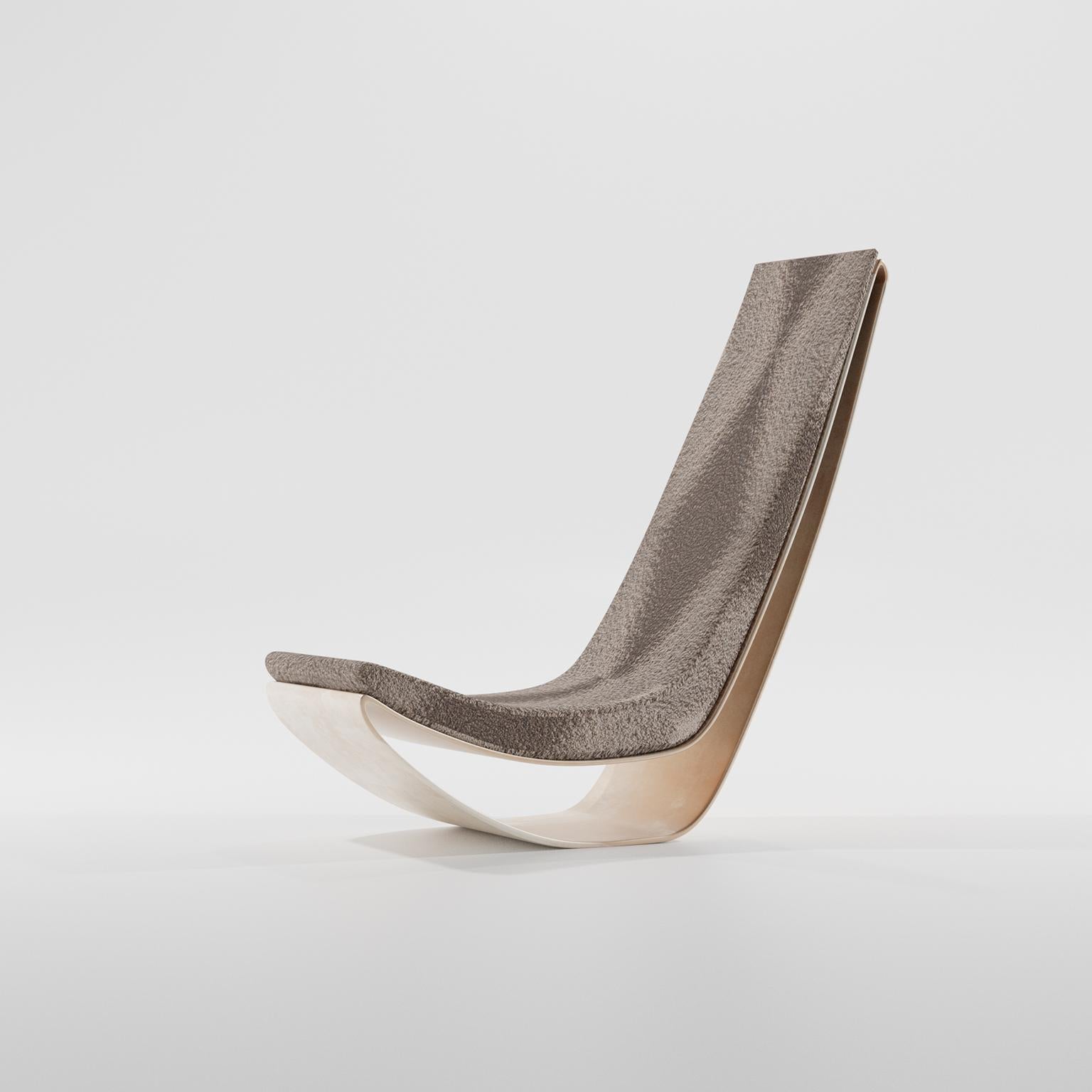 R1 lounge chair designed by Studio SORS. Blends the aesthetic of a rocking lounge chair to a fixed stable base. Signature upholstery models are numbered and signed.