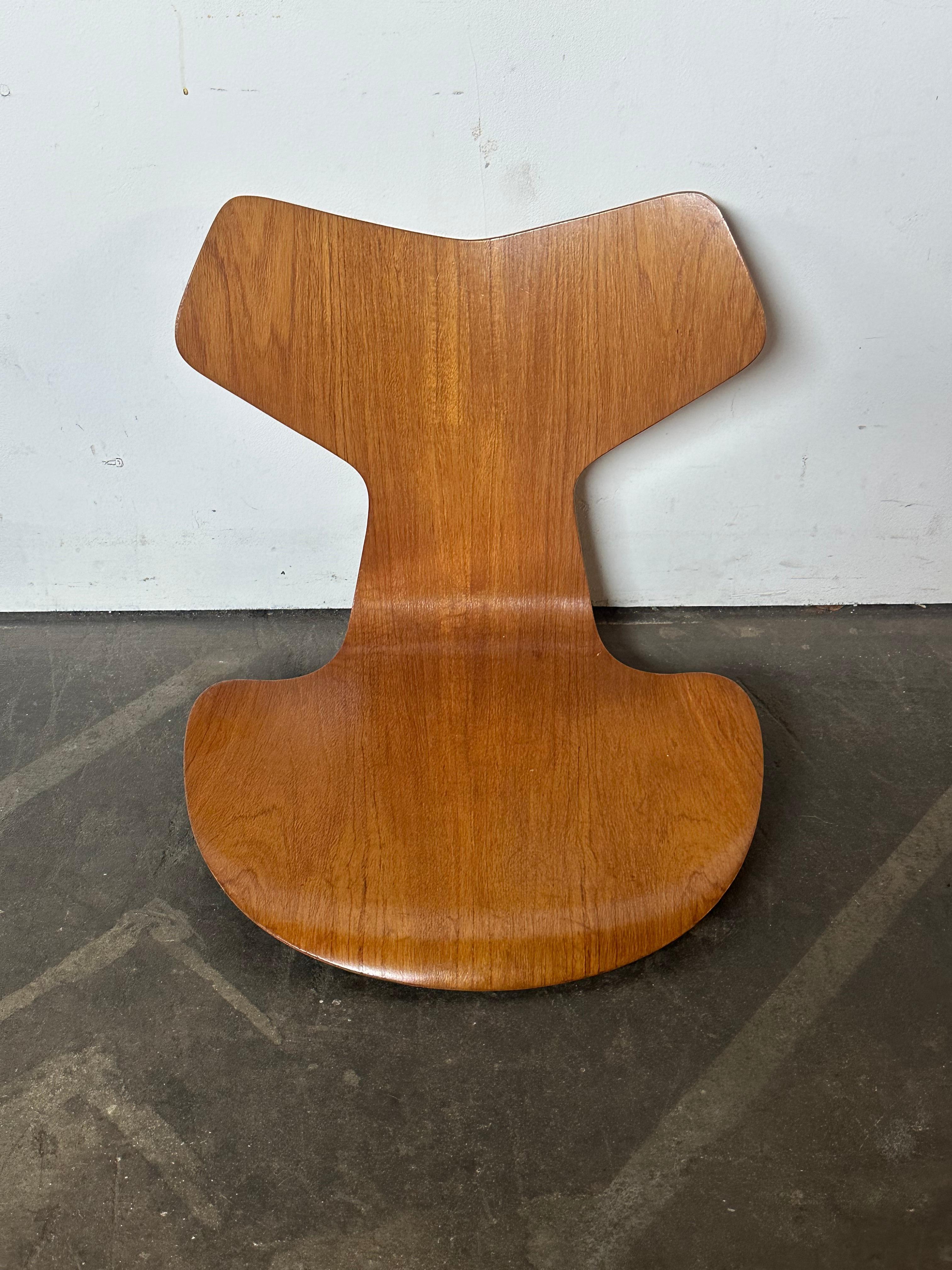 Beautiful teak chair top for Arne Jacobsen Grand Prix chair.  Lovely grain and finish, presents well and has gorgeous honey patina. Sourced from Denmark and a true vintage treasure. No base included. In even condition, impeccable wood grain and