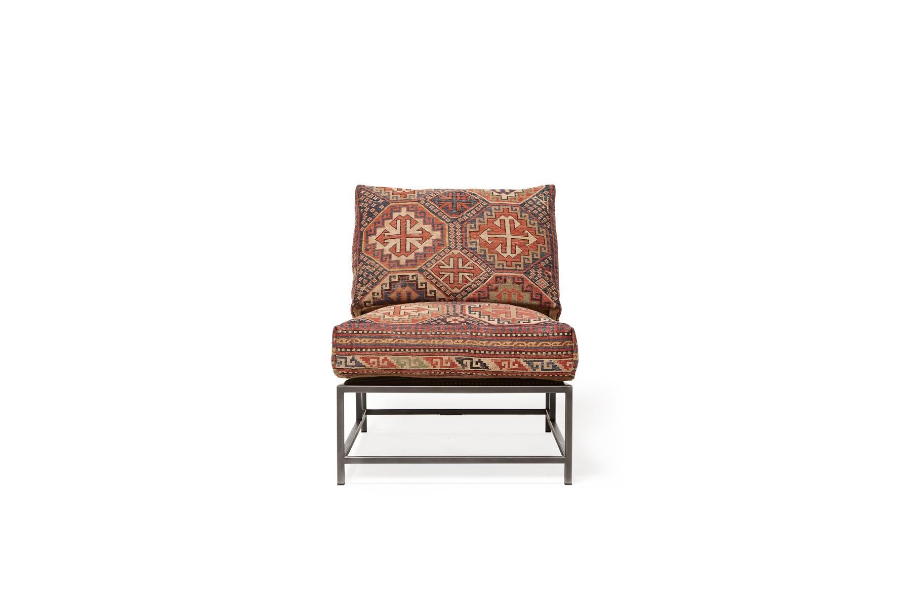 This chair, in the style of Stephen's Kenn Inheritance Collection, has been upholstered with an antique rug from the collection of King Kennedy rugs. The textile has been lovingly repaired and reinforced, without losing any of the beautiful