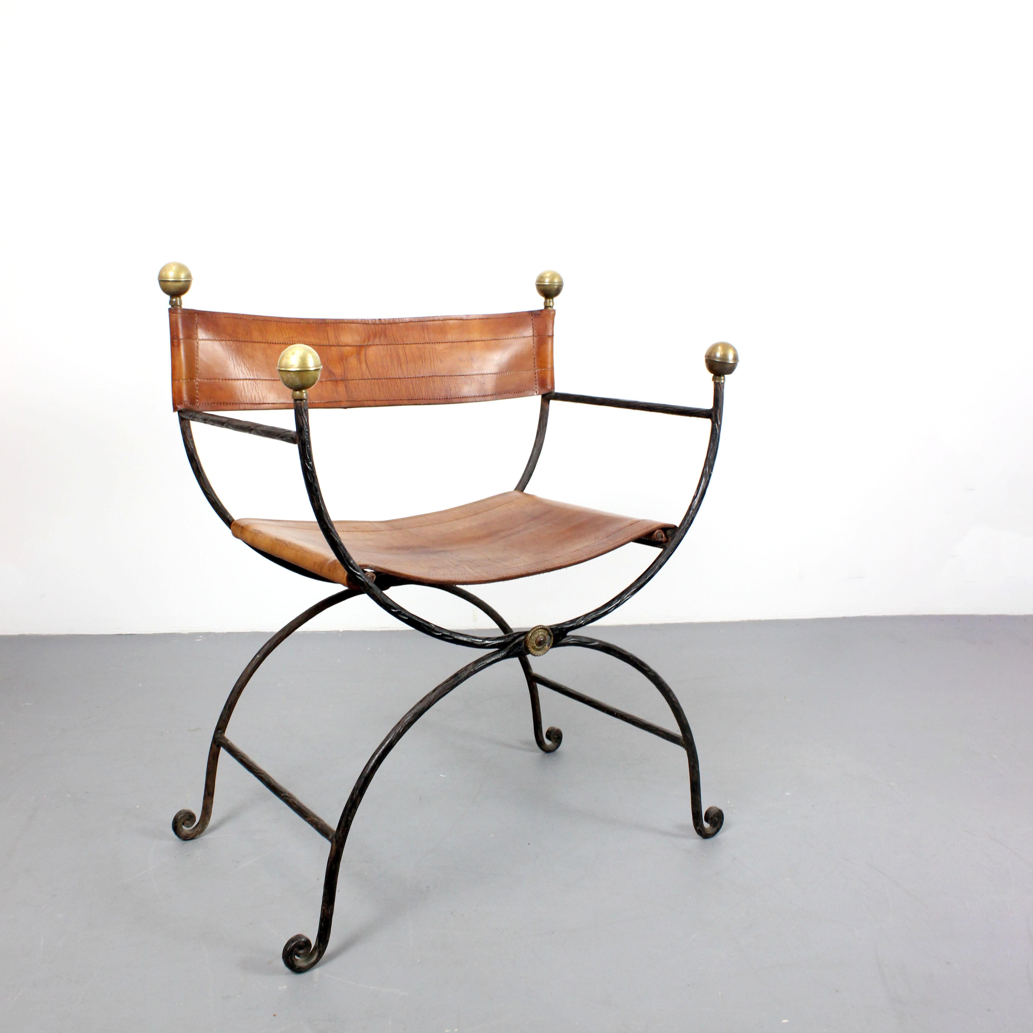 Chair with cast iron frame, gilt brass trim, and brown leather upholstery, following Italian models from the 17th - 20th centuries.