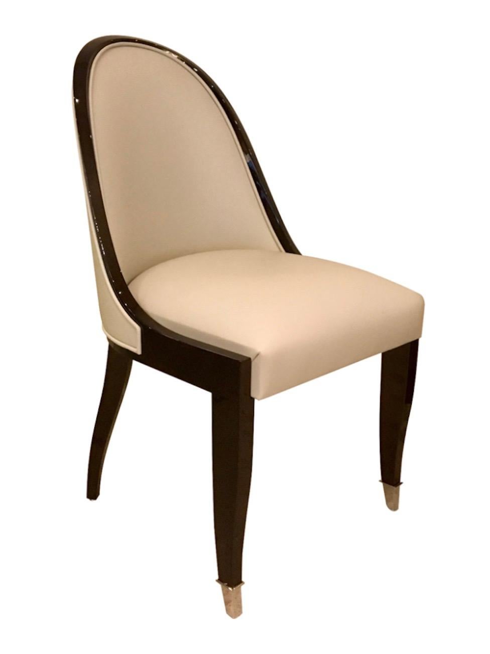 Elegant Art Deco chair with beautifully narrow curved backrest. 
This is the most famous Art Deco chair shape. 
Very elaborate in production, offers excellent seating comfort. 

High quality! Handmade in Germany. 

Lacquered Wood. 
Two metal