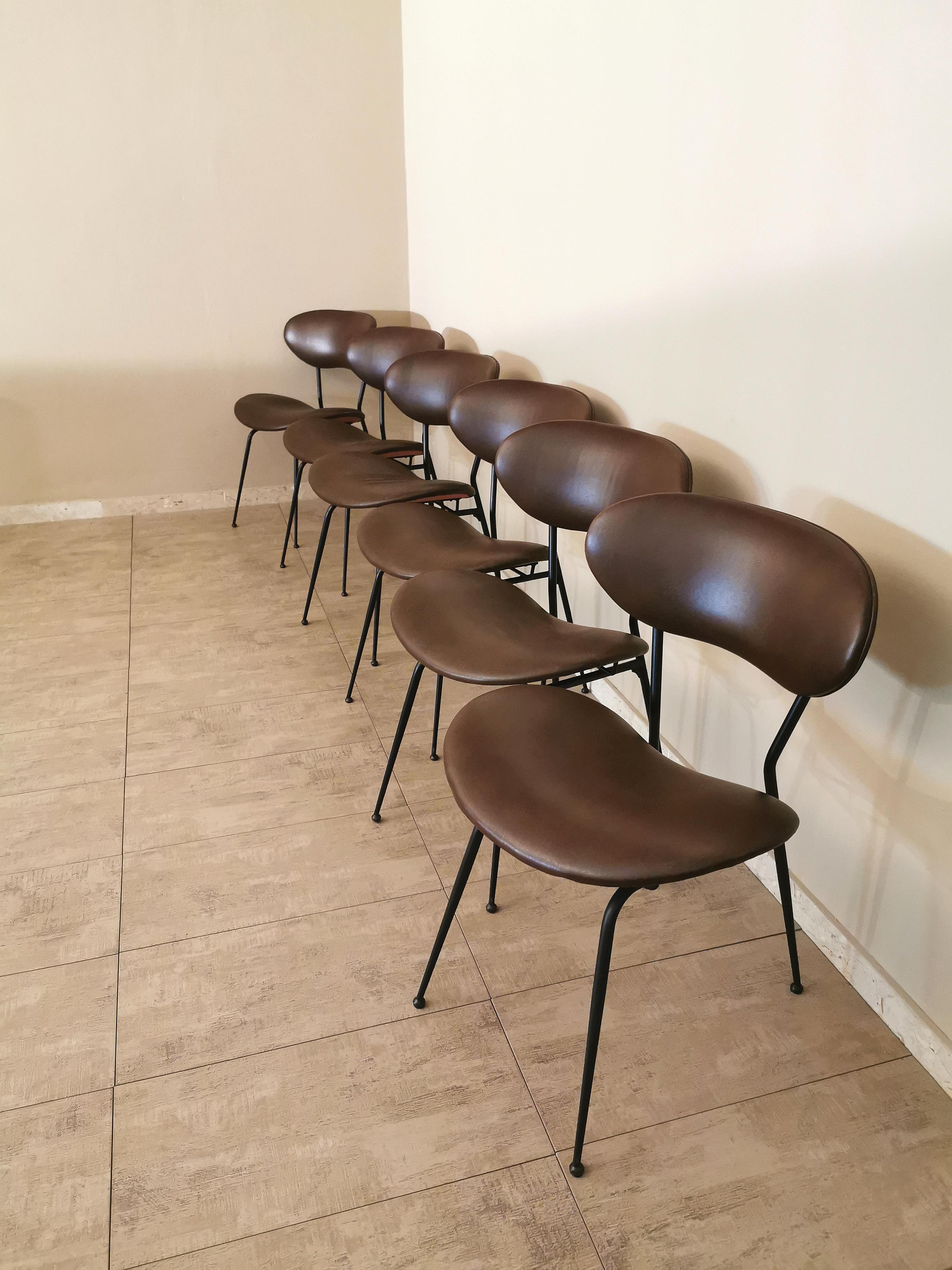 Set of 6 dining chairs designed by the Italian designer Gastone Rinaldi with black enamelled metal structure, anatomical seats and backrests covered in brown leather-eco-leather. Note the slender and elegant line of the structure and despite its