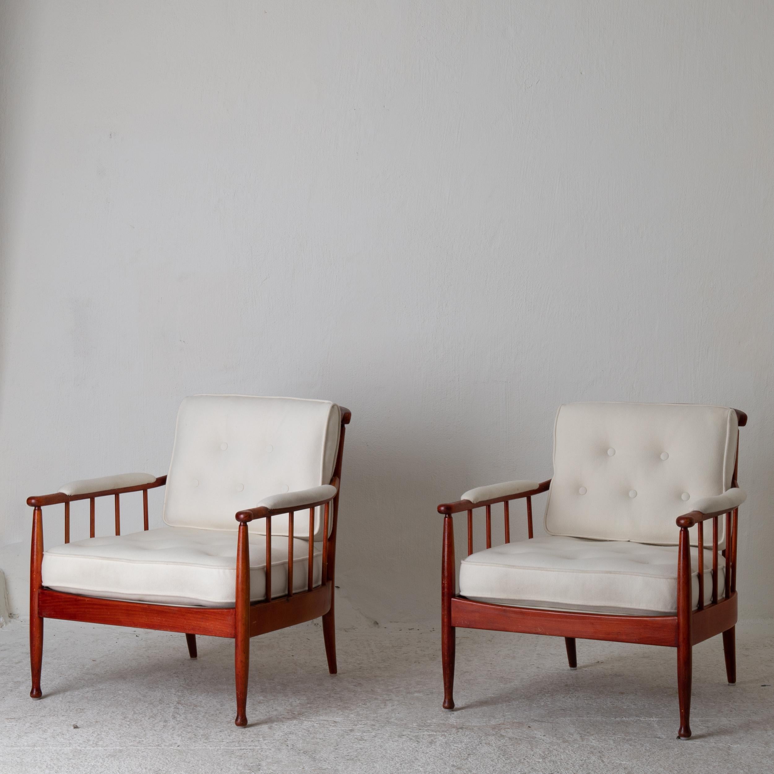 A pair of lounge chairs made by Kerstin Hörlin-Homqvist during the 1960s in Sweden. Upholstered in an off white wool fabric with piping details.

 