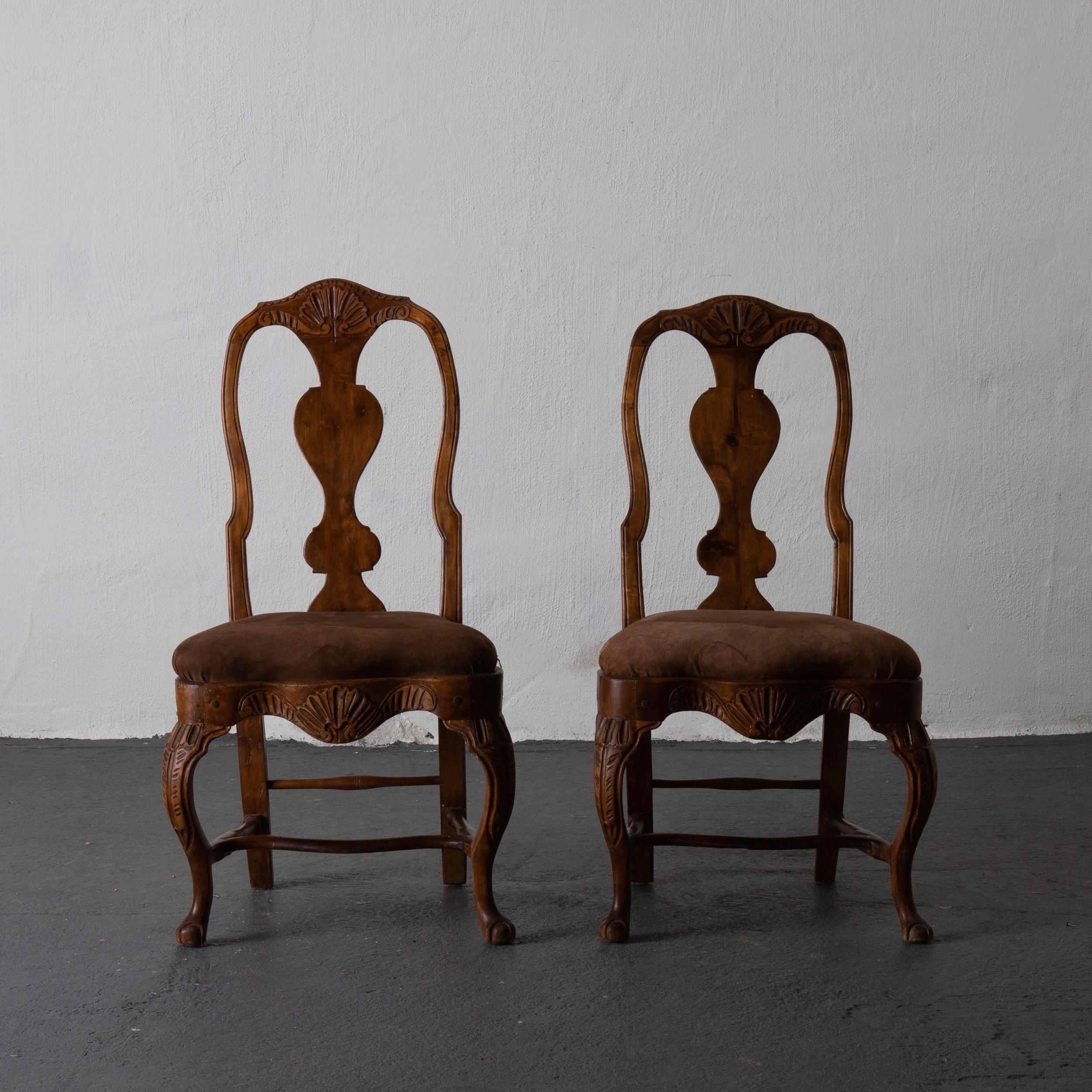 A pair of beautiful Swedish Rococo side chairs from the west part of Sweden. Made during the Rococo period and upholstered in a chocolate brown suede. 

  