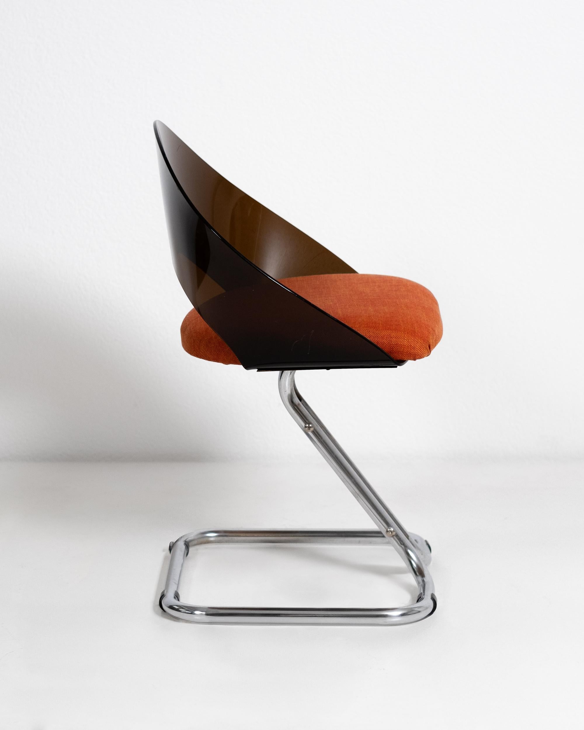 This rare set of four Space Age chairs from the 1960s is a striking example of early futuristic design that emerged in post-war Italy, reflecting the optimism and experimentation of the era. With elegantly curved smoked plexiglass seats and sleek