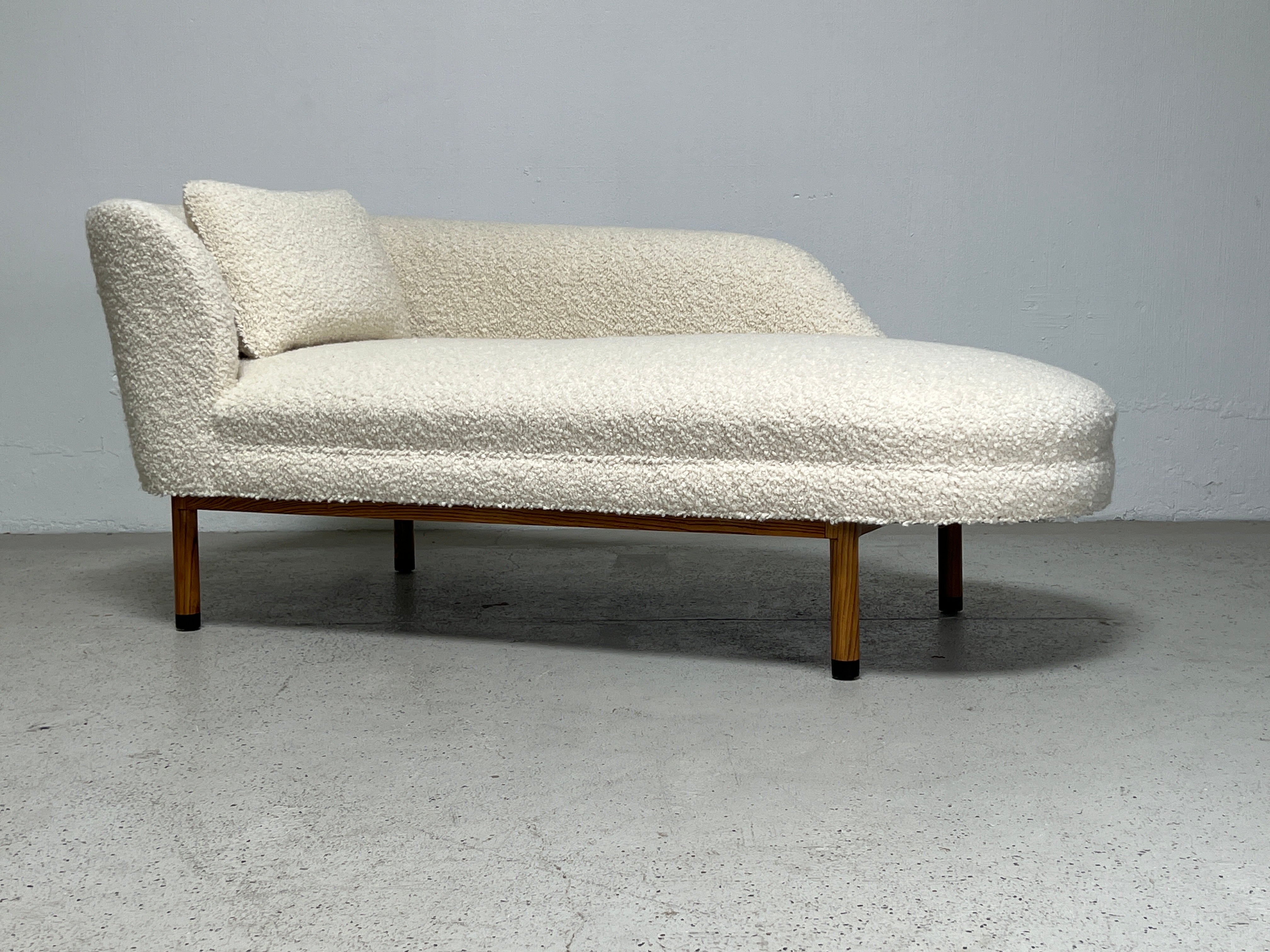 A left arm chaise lounge designed by Edward Wormley for Dunbar. Ash base with Ebony feet. Fully restored and upholstered in Holly Hunt / Teddy / Winter White. Matching right arm chaise also available. 