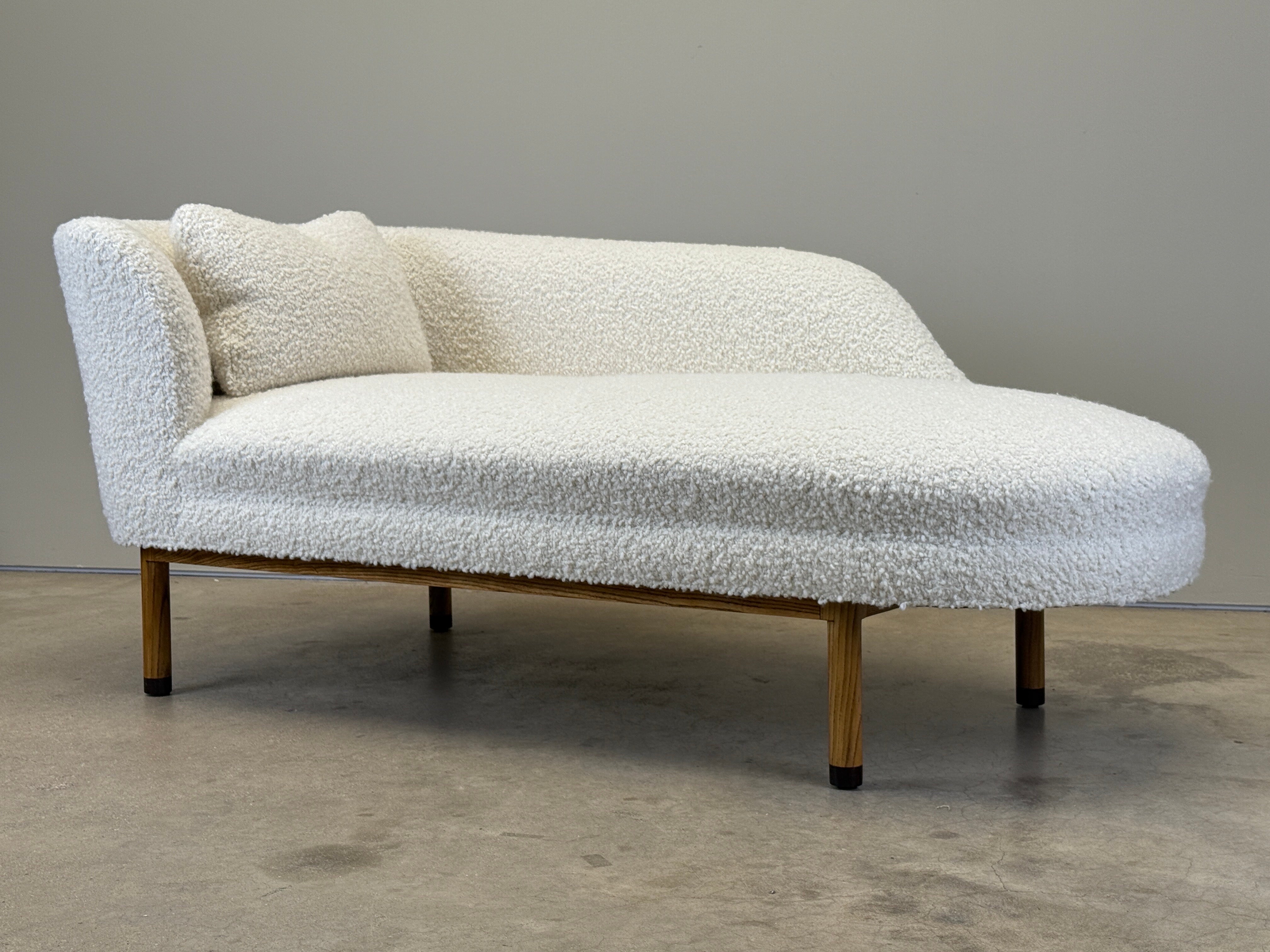 A left arm chaise lounge designed by Edward Wormley for Dunbar. Ash base with Ebony feet. Fully restored and upholstered in Holly Hunt / Teddy / Winter White.