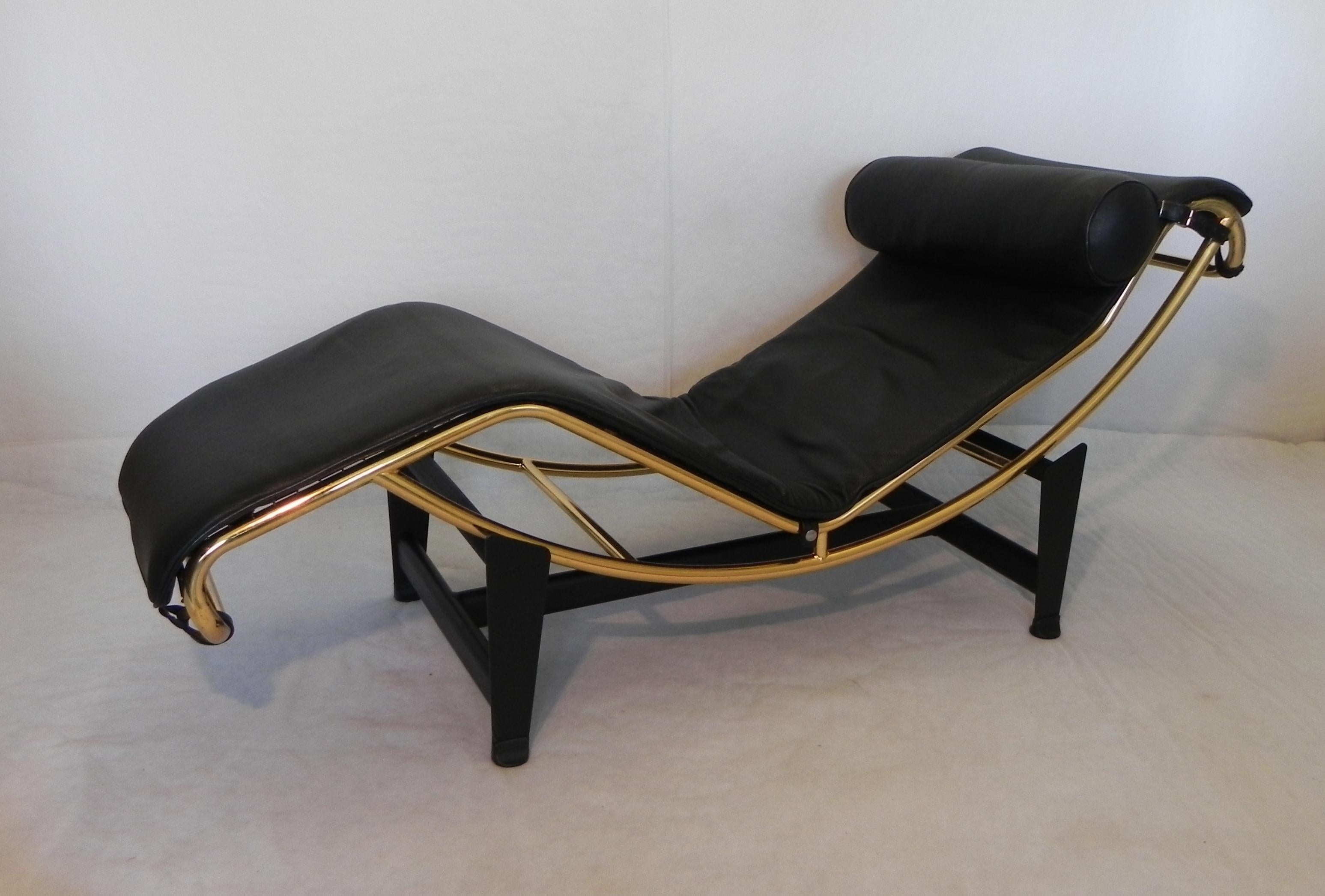 Bauhaus-inspired chaise longue, limited edition. 1980s. galvanized shaft GOLD color. (one of a kind). black base, high quality leather cushioning black color. armchair is used, bears few signs of time. photographed here with its Cage side table, by