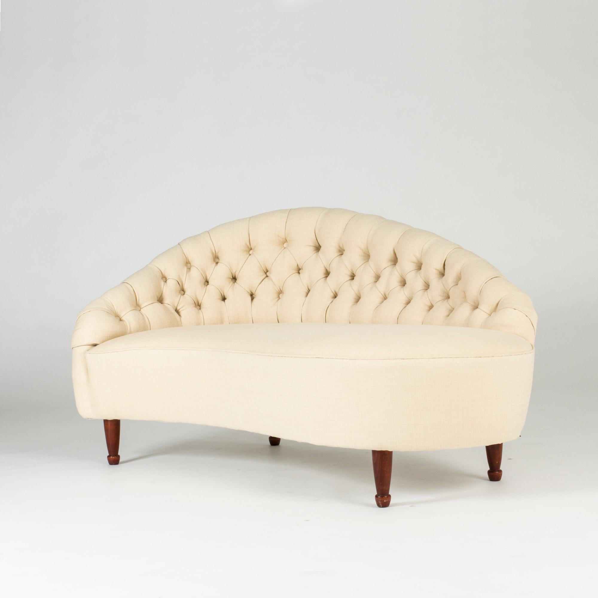 Stunning chaise longue by Carl Cederholm, upholstered in eggshell white linen fabric. Beautiful sweeping lines. Elegantly sculpted stained wood feet.